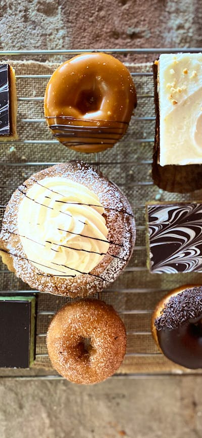 trapper donuts with chocolate eclairs and apple pies
