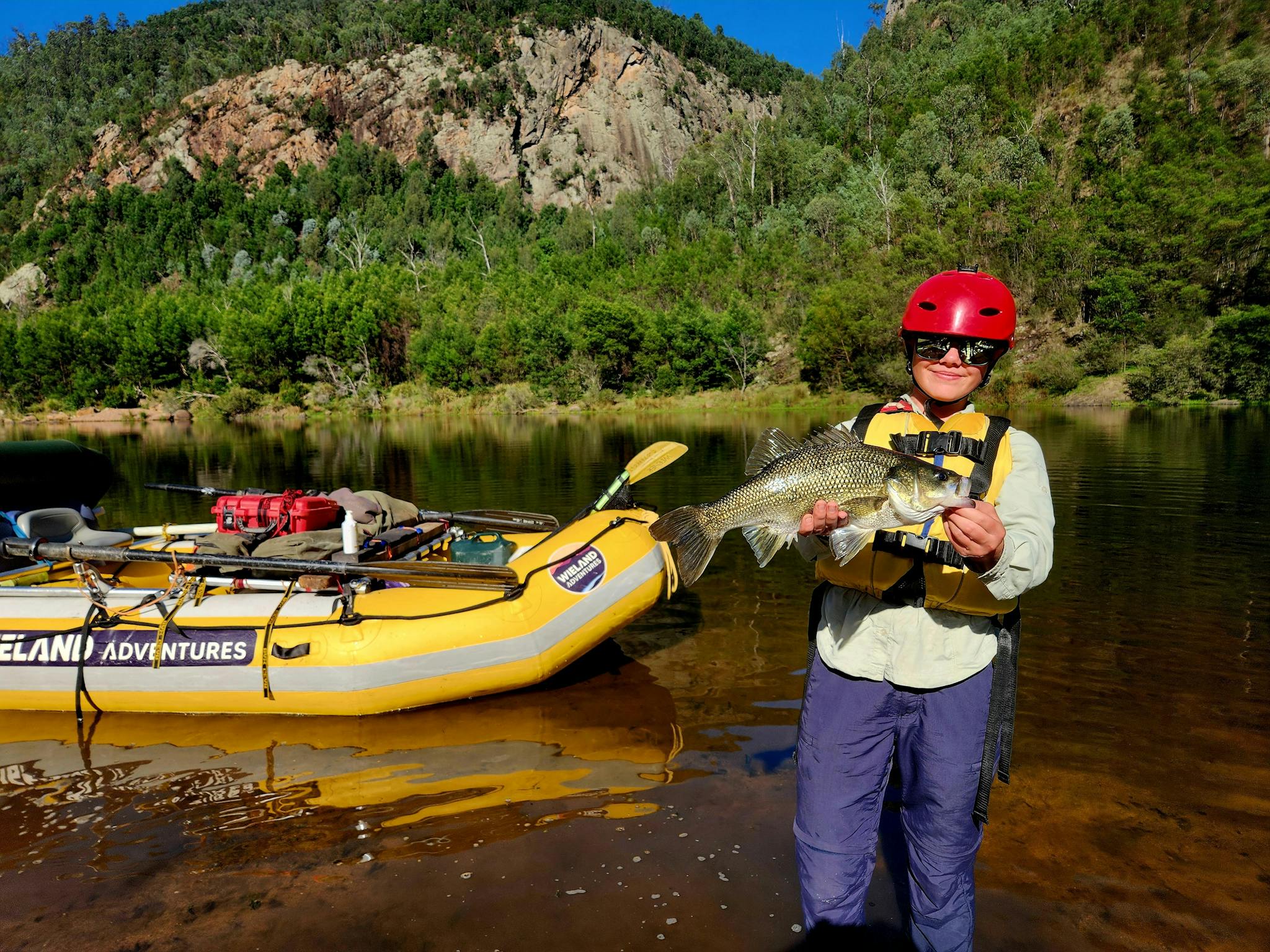 A female client on the Snowy River holding an Austrlian Bass she caught