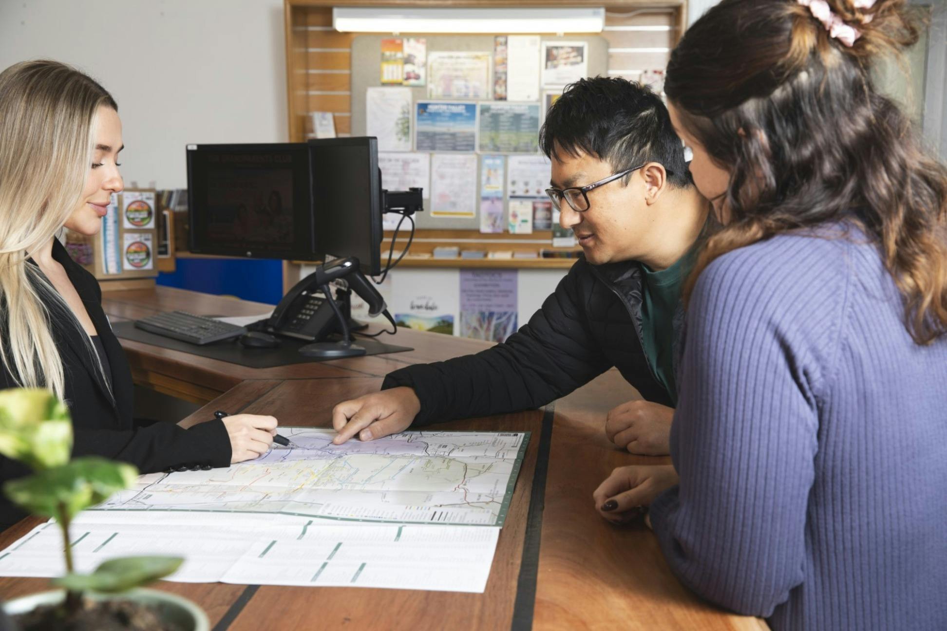 Visitors with map at Visitor Centre counter