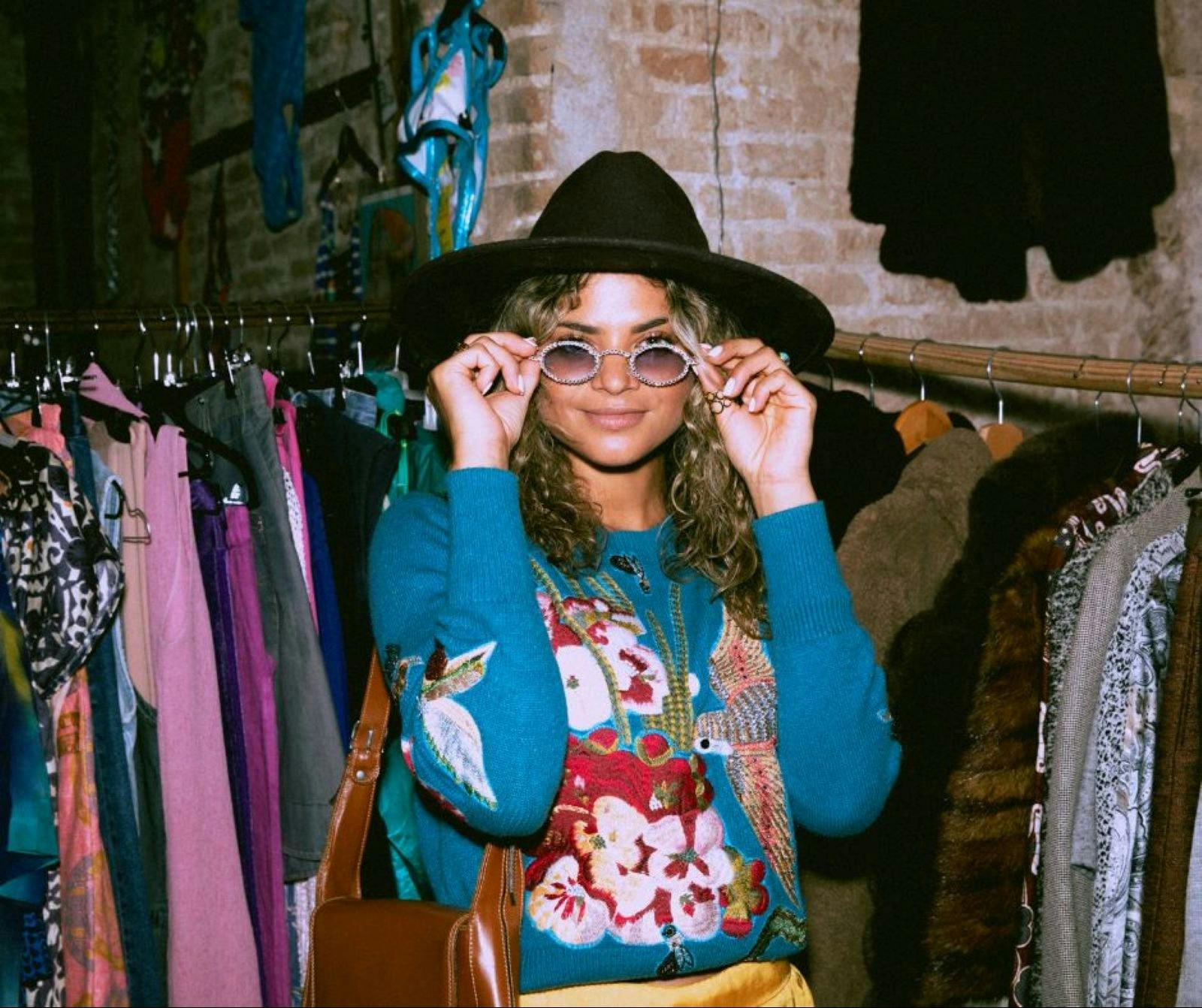 lady trying on clothes and sunglasses