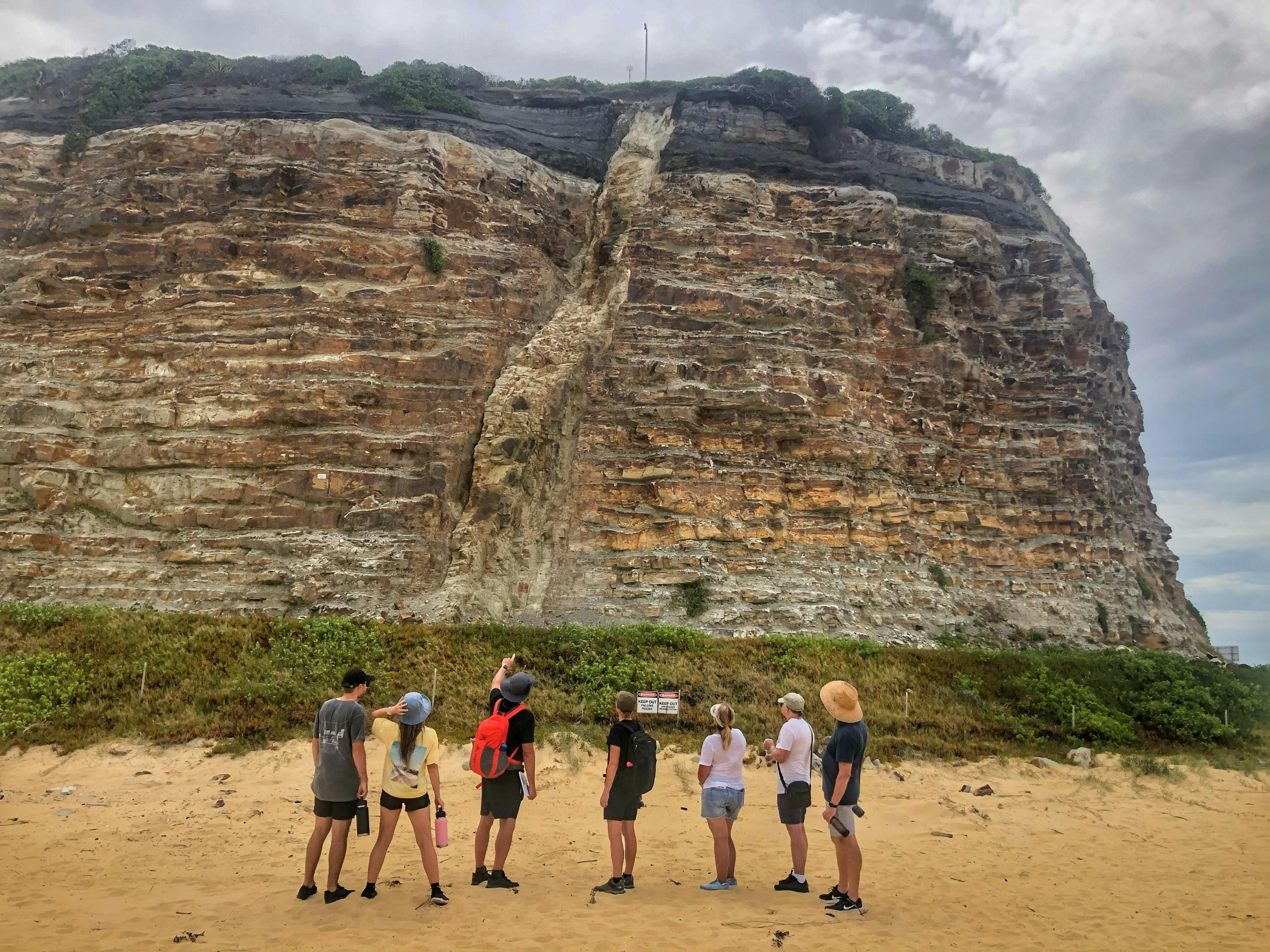A group of people looking at a headland