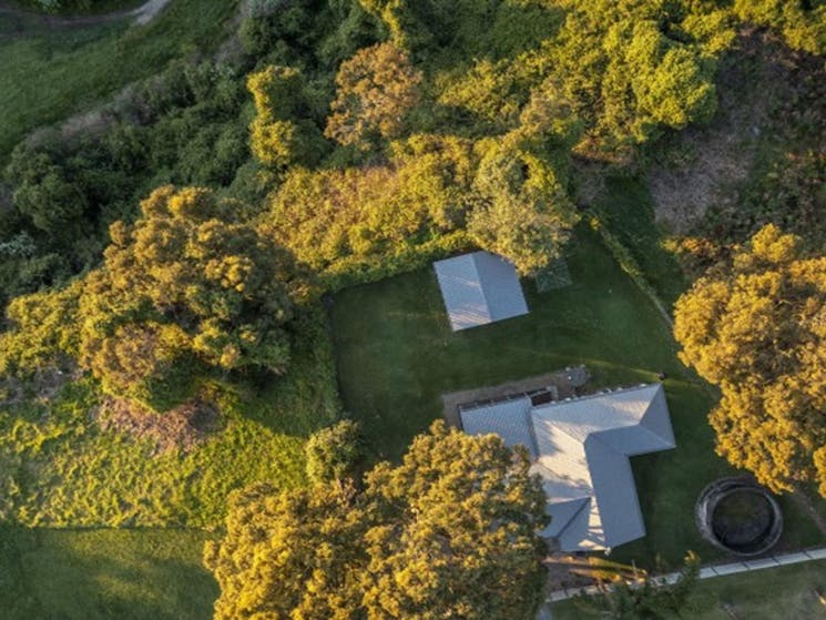 An aerial view of Baileys Cottage surrounded by trees in Glenrock State Conservation Area. Photo:
