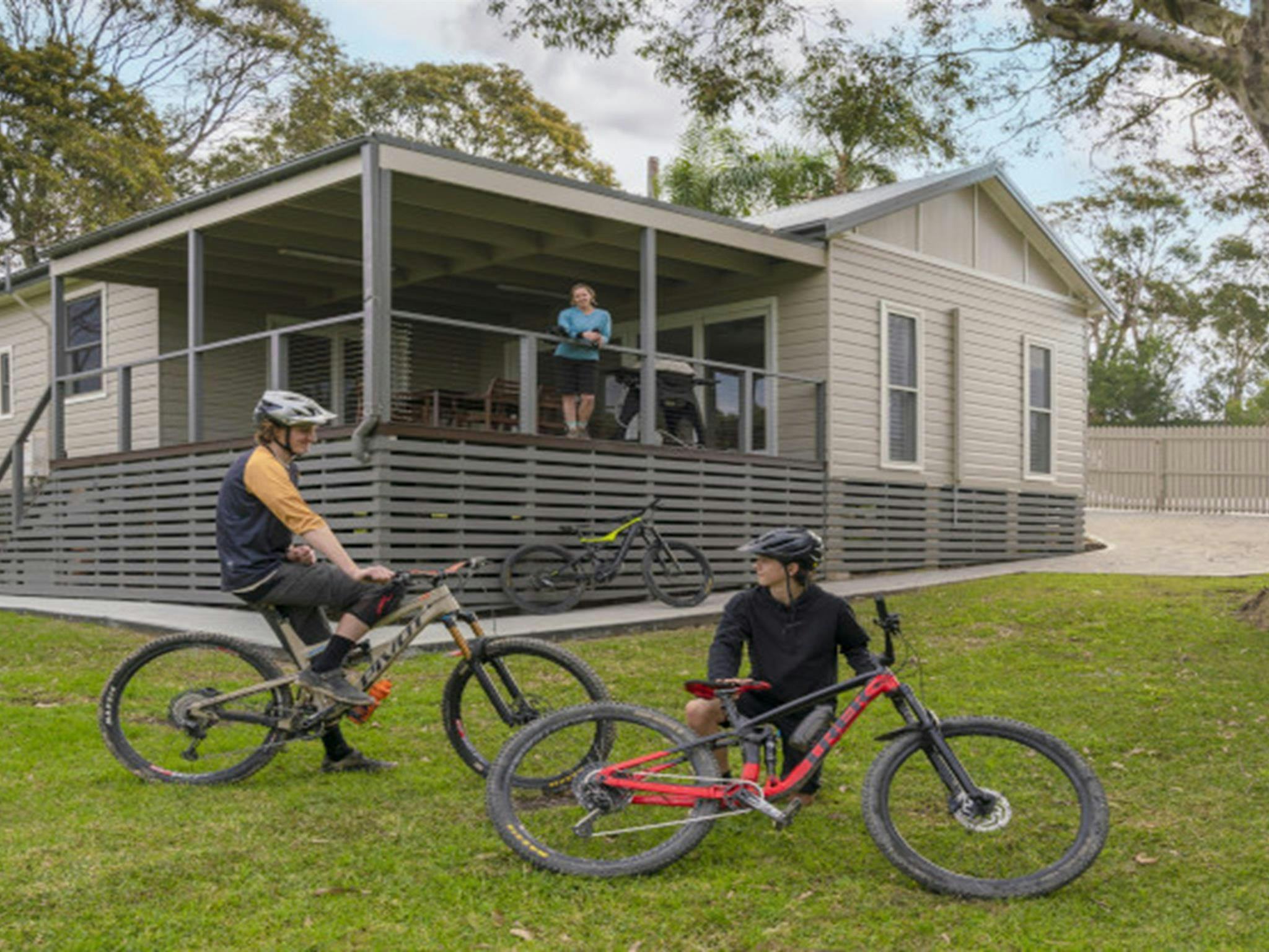 Guests on bikes in front of Baileys Cottage. Photo: John Spencer &copy; DPE