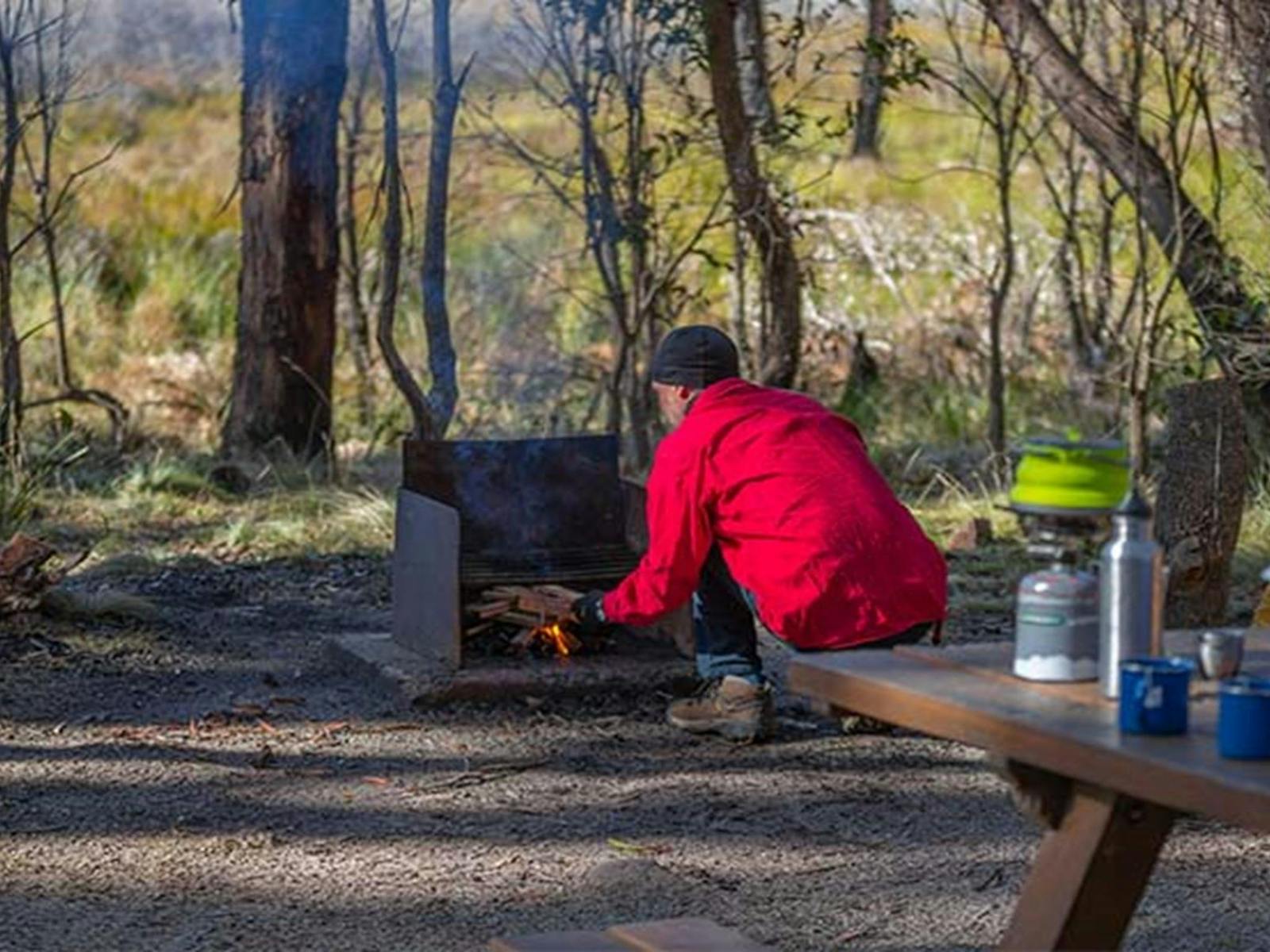 A camper lighting a bbq at Barokee campground, Cathedral Rock National Park. Photo: Josh Smith