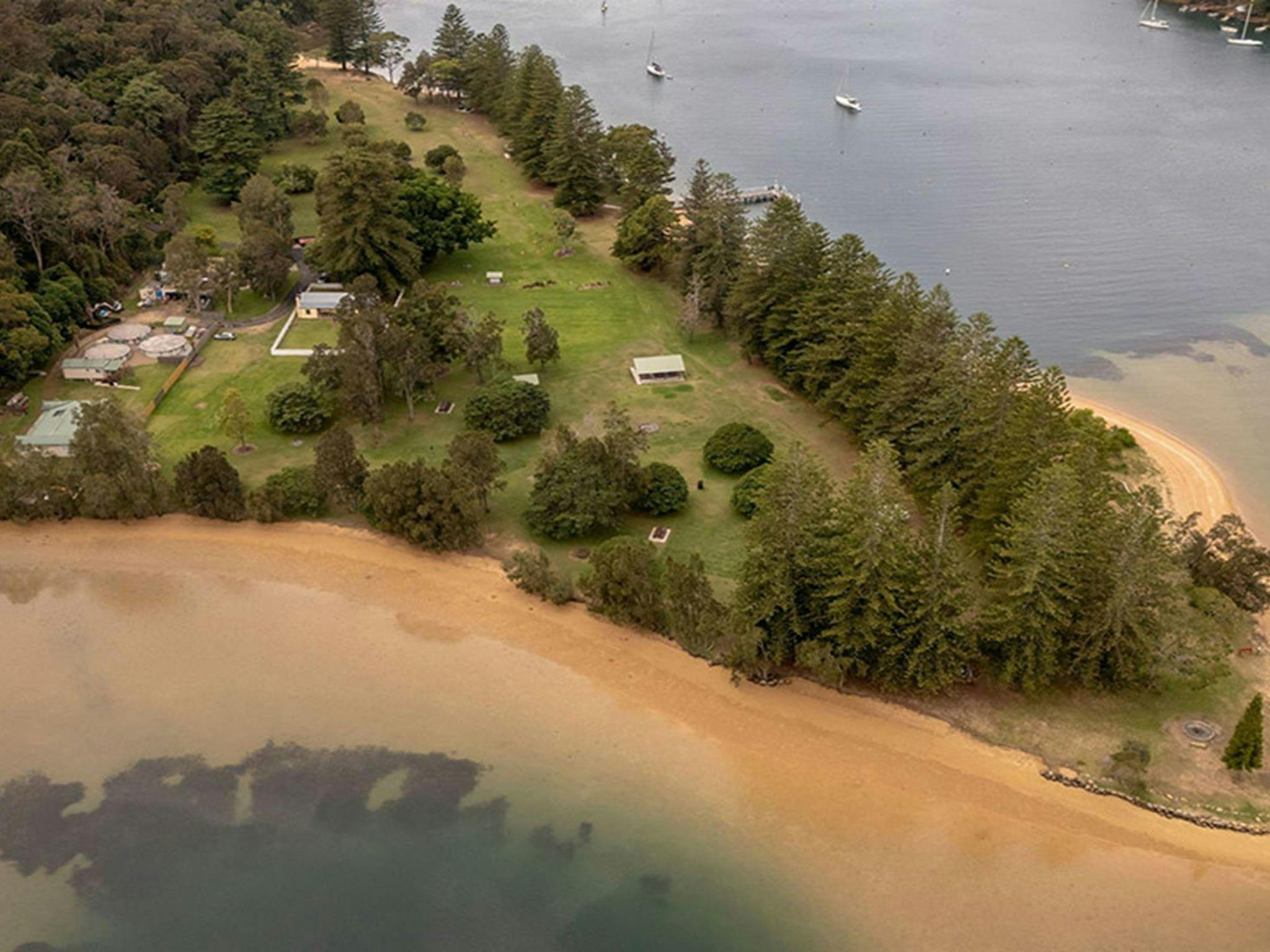 Aerial view of The Basin campground surrounded by The Basin lagoon. Credit: John Spencer/DCCEEW