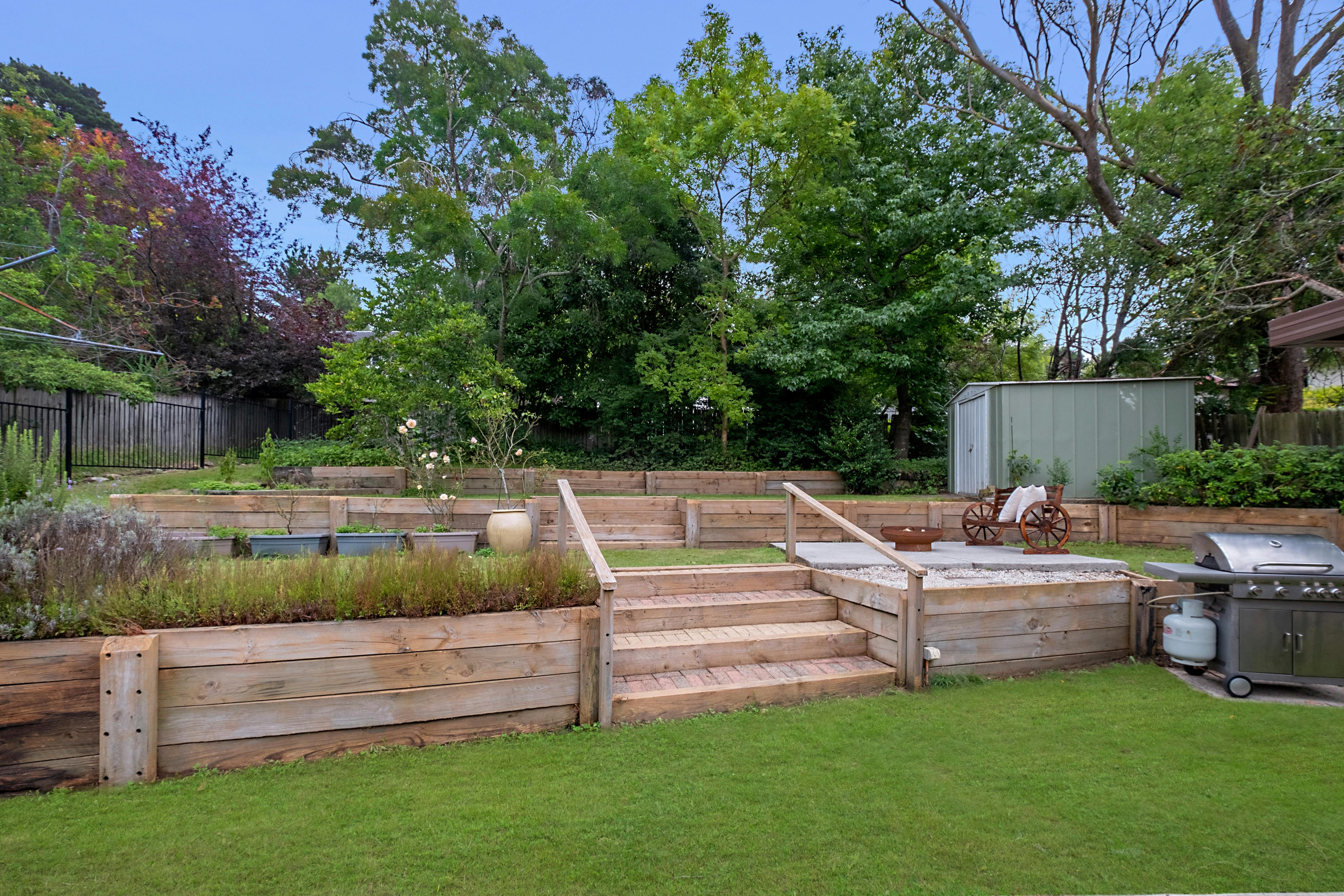 Terraced back garden with patio seating area, gas BBQ and firepit, to relax and entertain.