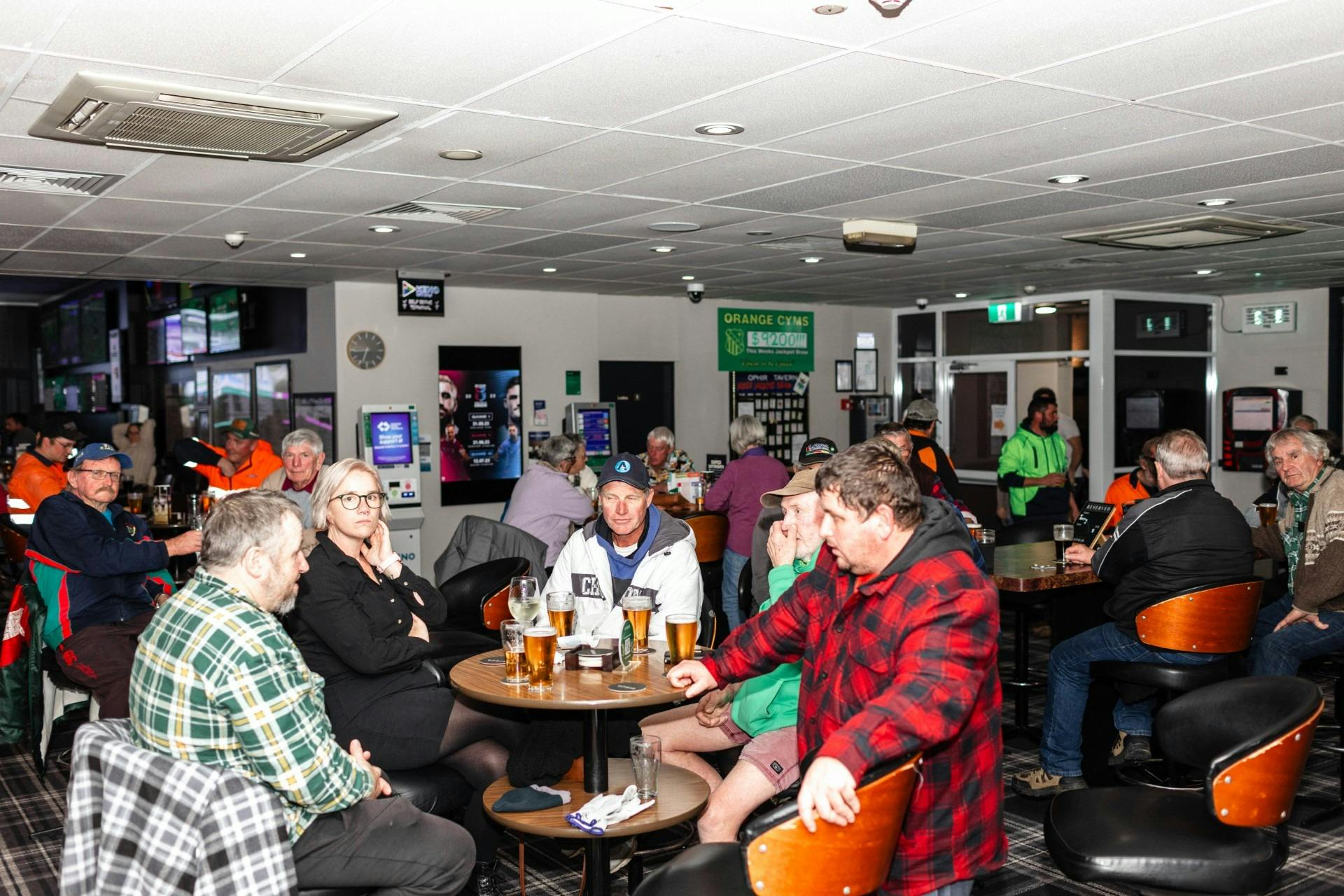 Full room of people in the sports bar