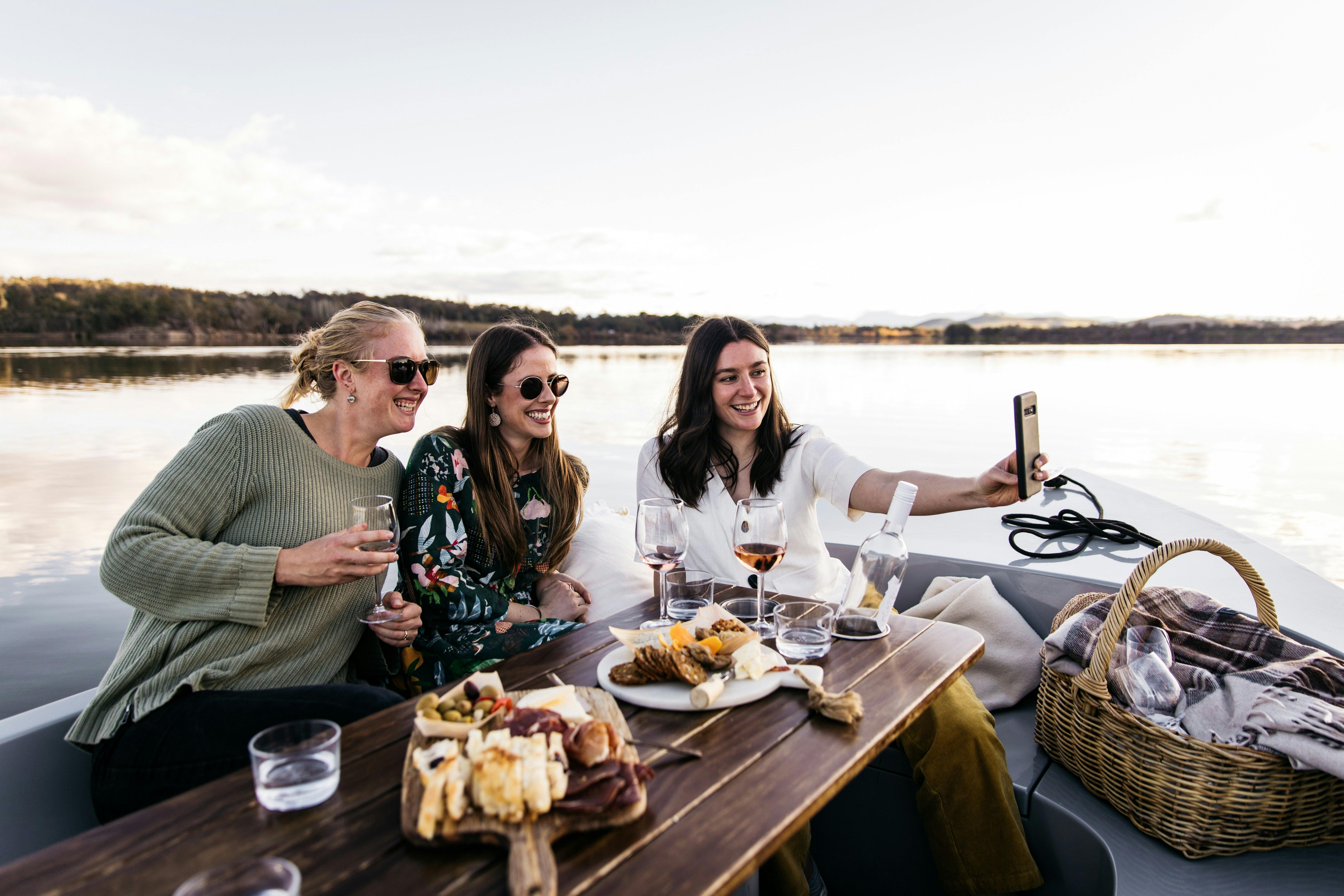 Three women taking a selfie on a boat