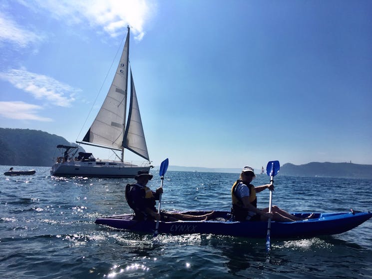 Kayaking near sailing boats on Pittwater.