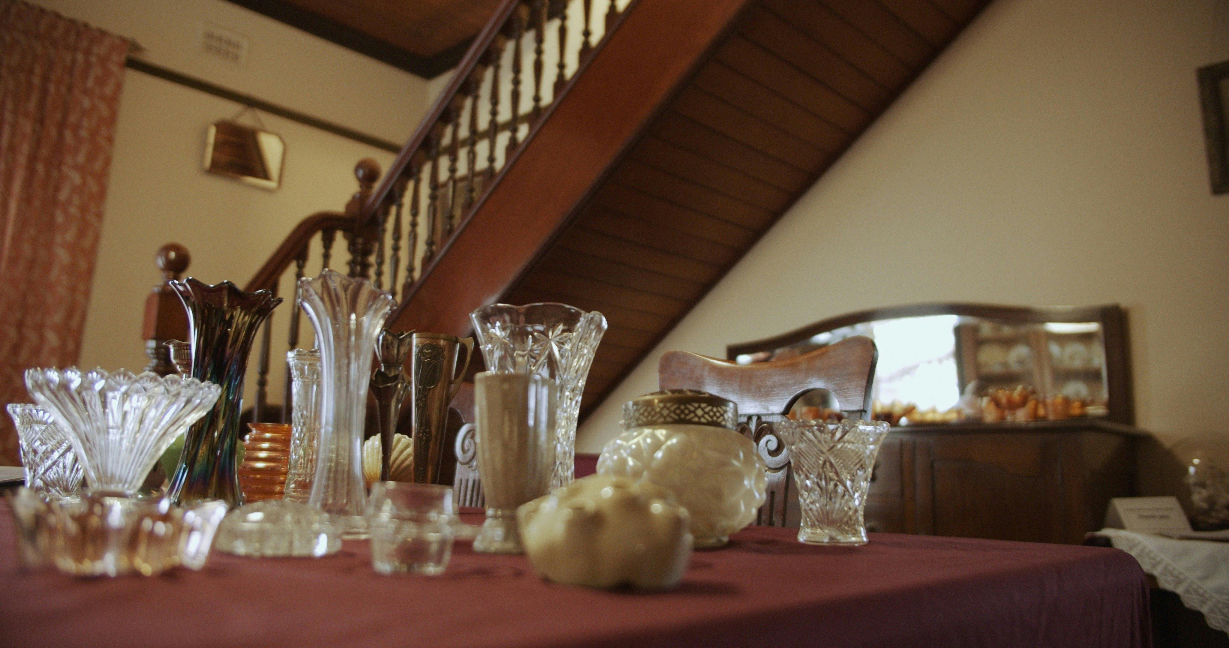 Dining Room with staircase. Table has display of vases from Miss Porter's House collection.