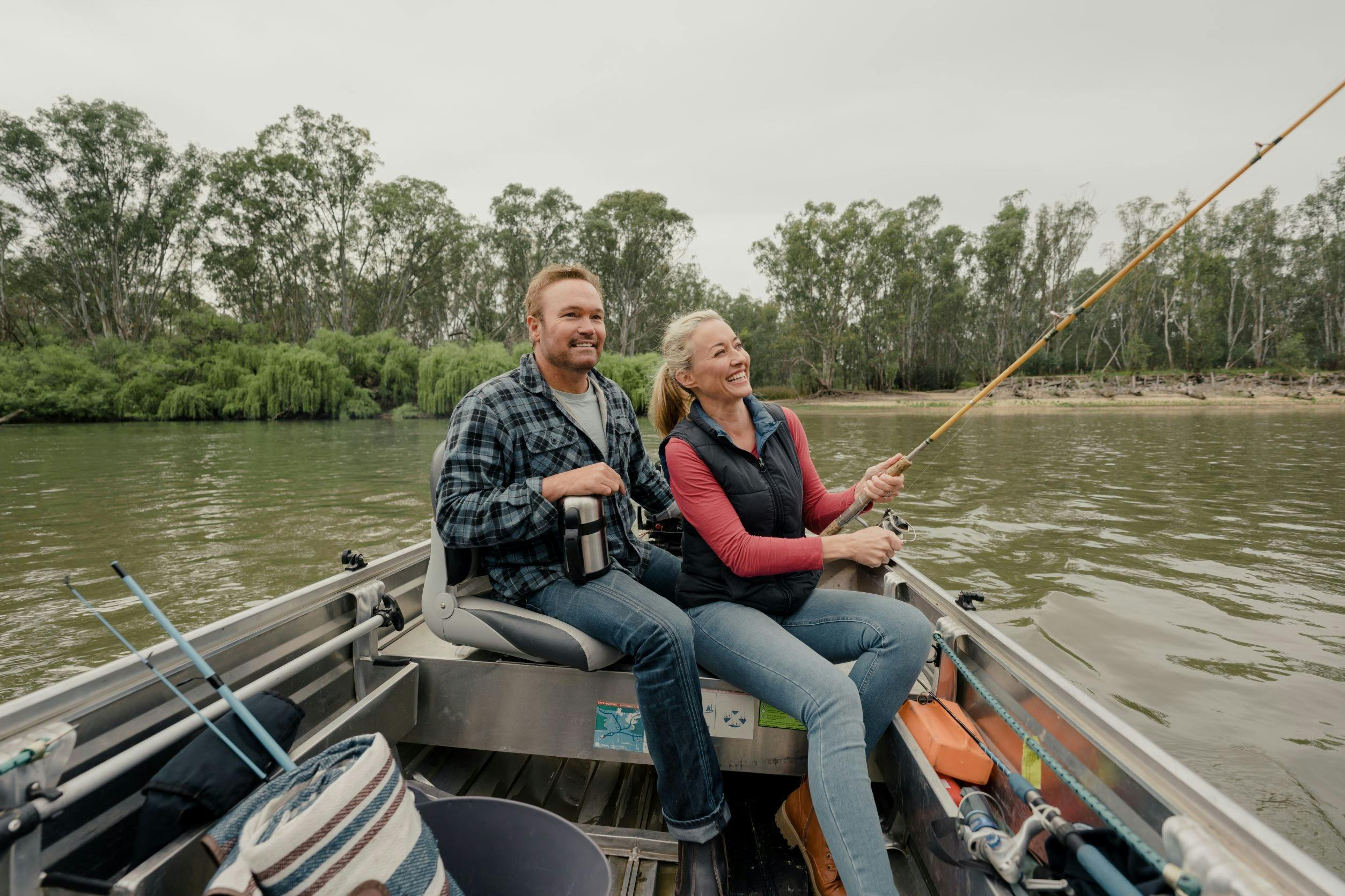Couple sitting on a tinnie fishing the Murray river at Corowa