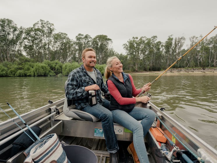 Couple sitting on a tinnie fishing the Murray river at Corowa
