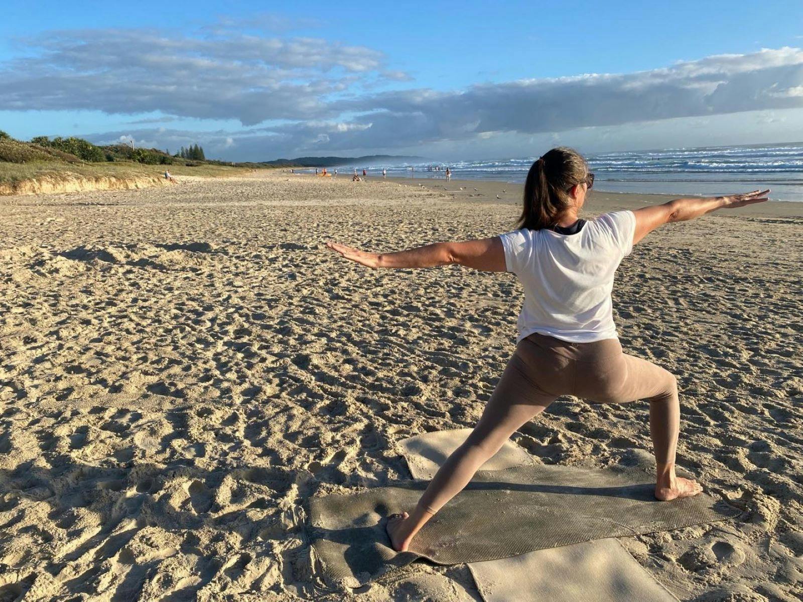 Lady doing yoga on beach