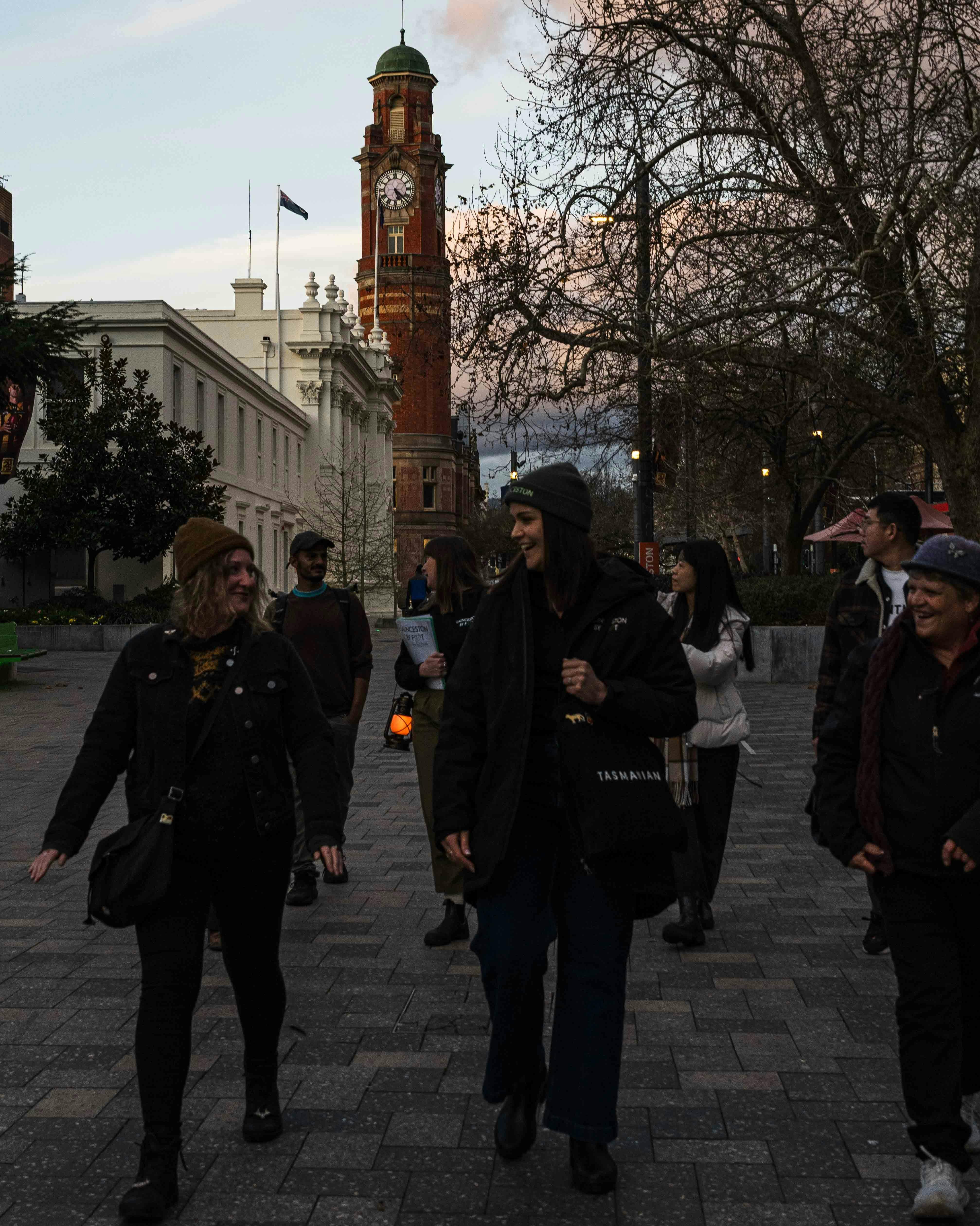 Guests walking through Civic Square with Launceston By Foot guides at dusk.