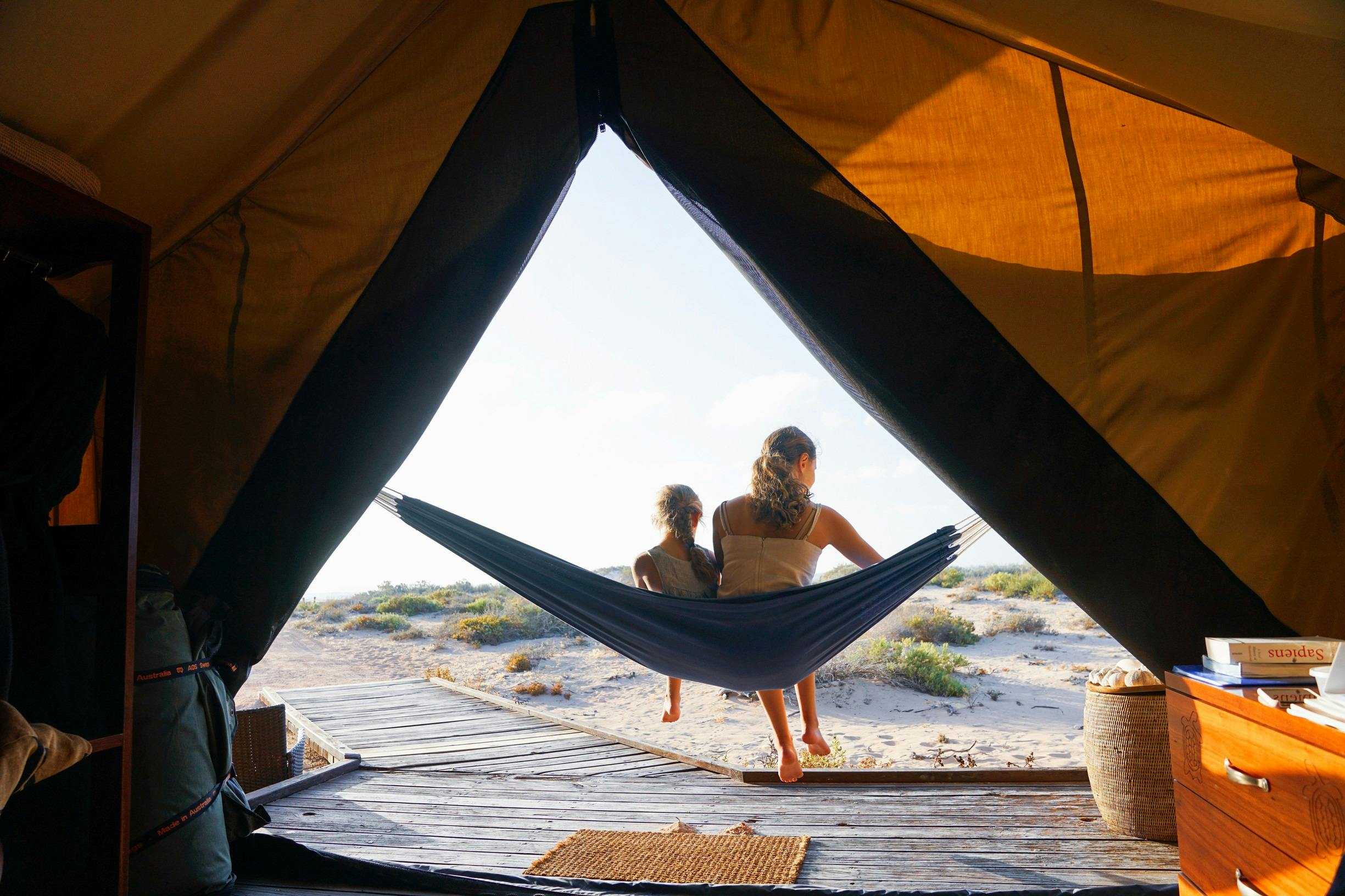 Children on a hammock at luxury retreat, Sal Salis in Ningaloo