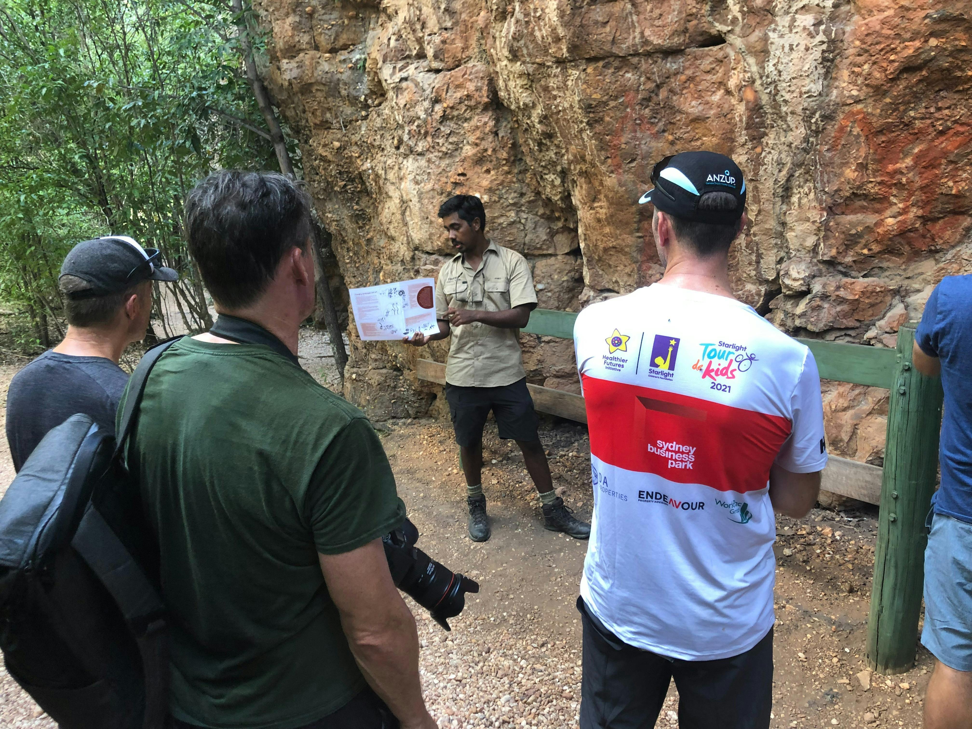 Riders receiving guided rock art tour with James, Kakadu