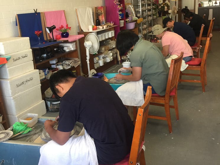 A household family doing pottery together