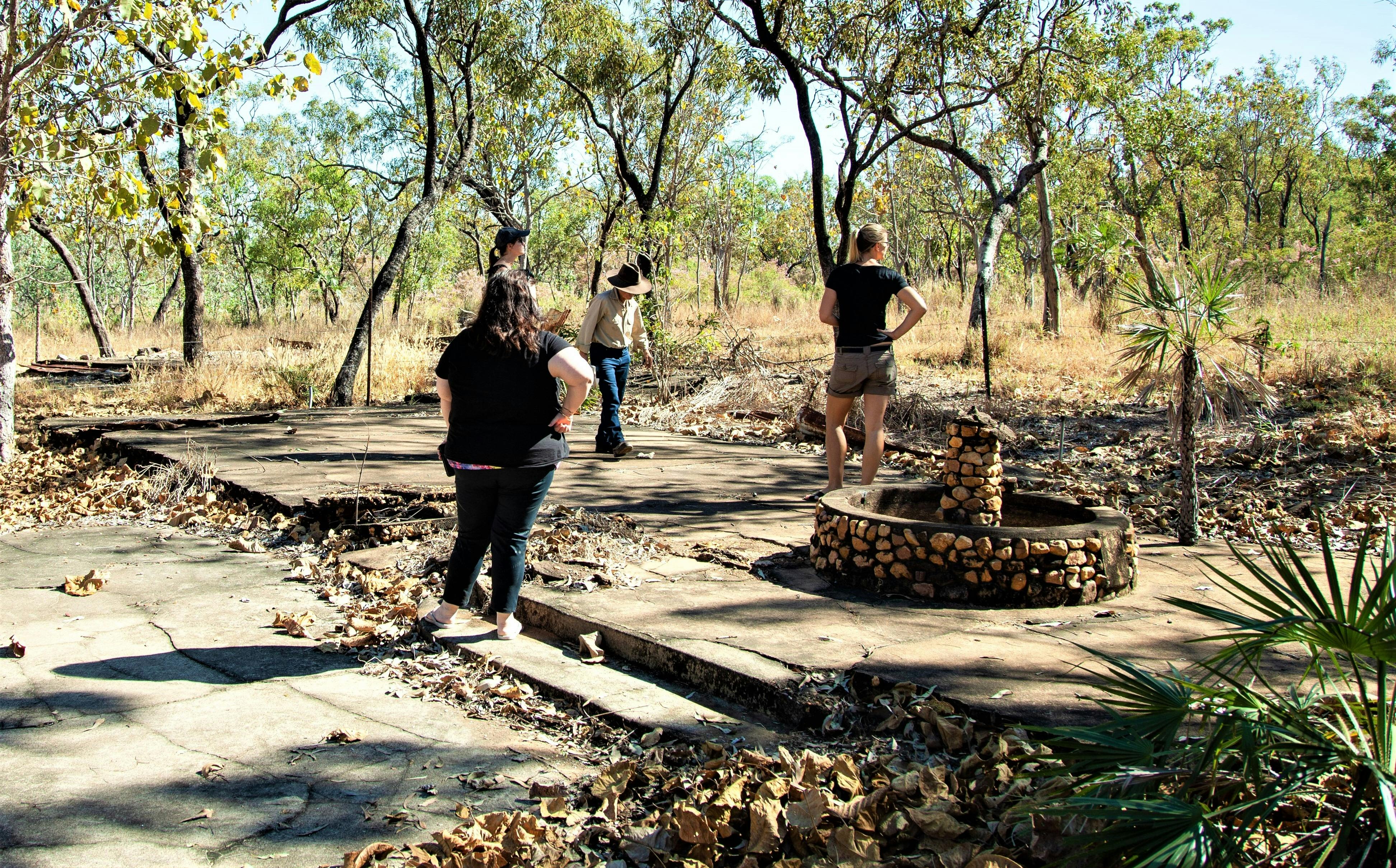 People walk across the remnants of a WWII building