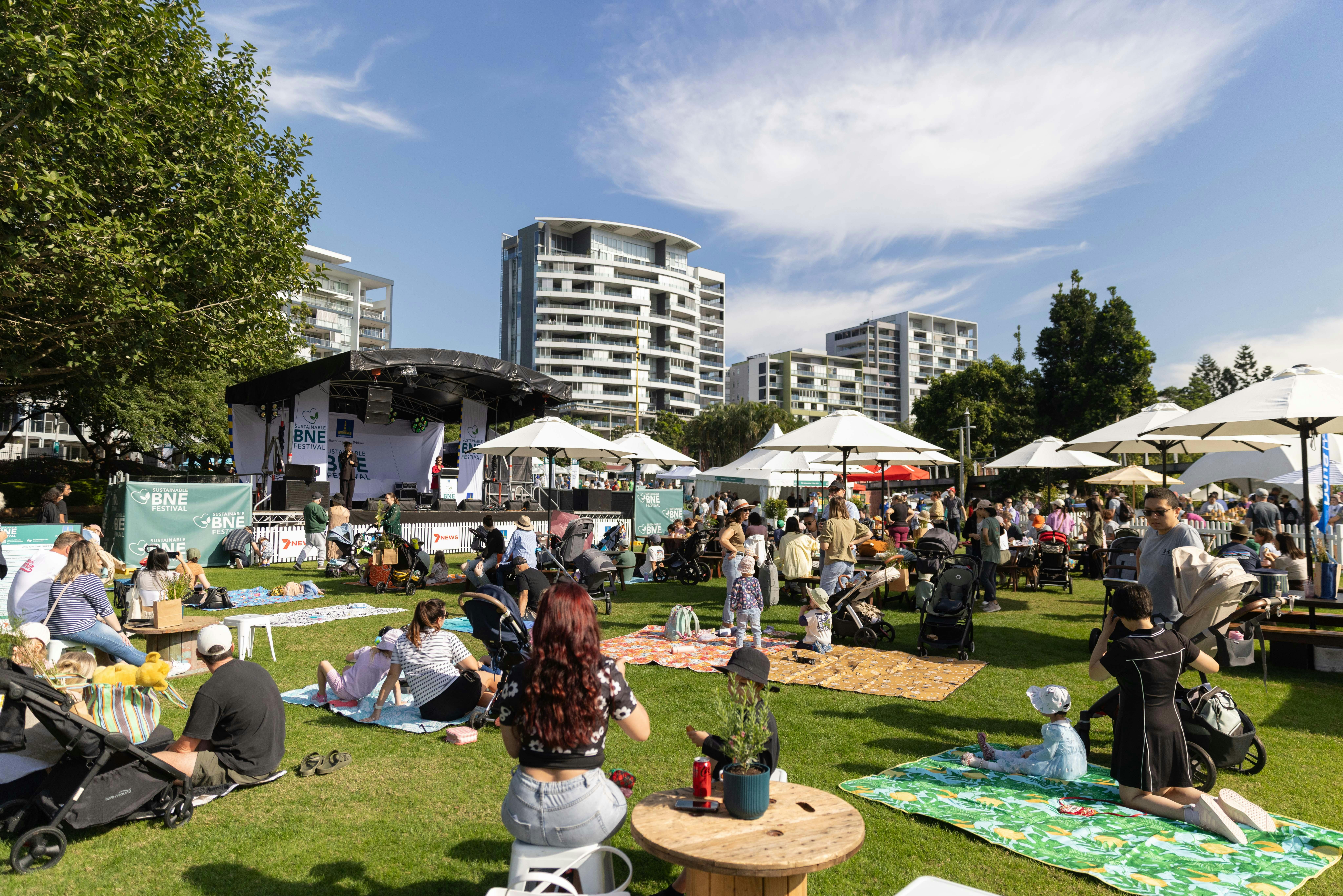 Image of a crowd of people sitting and watching the stage at Roma Street Parkland