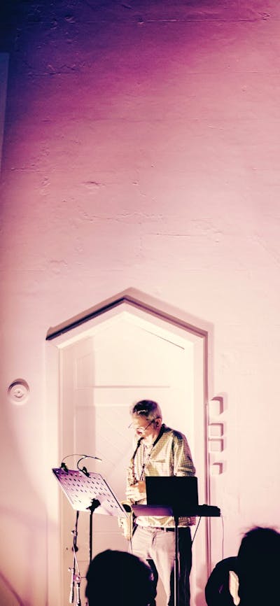 Pictured is Phillip Johnston performing with his saxophone