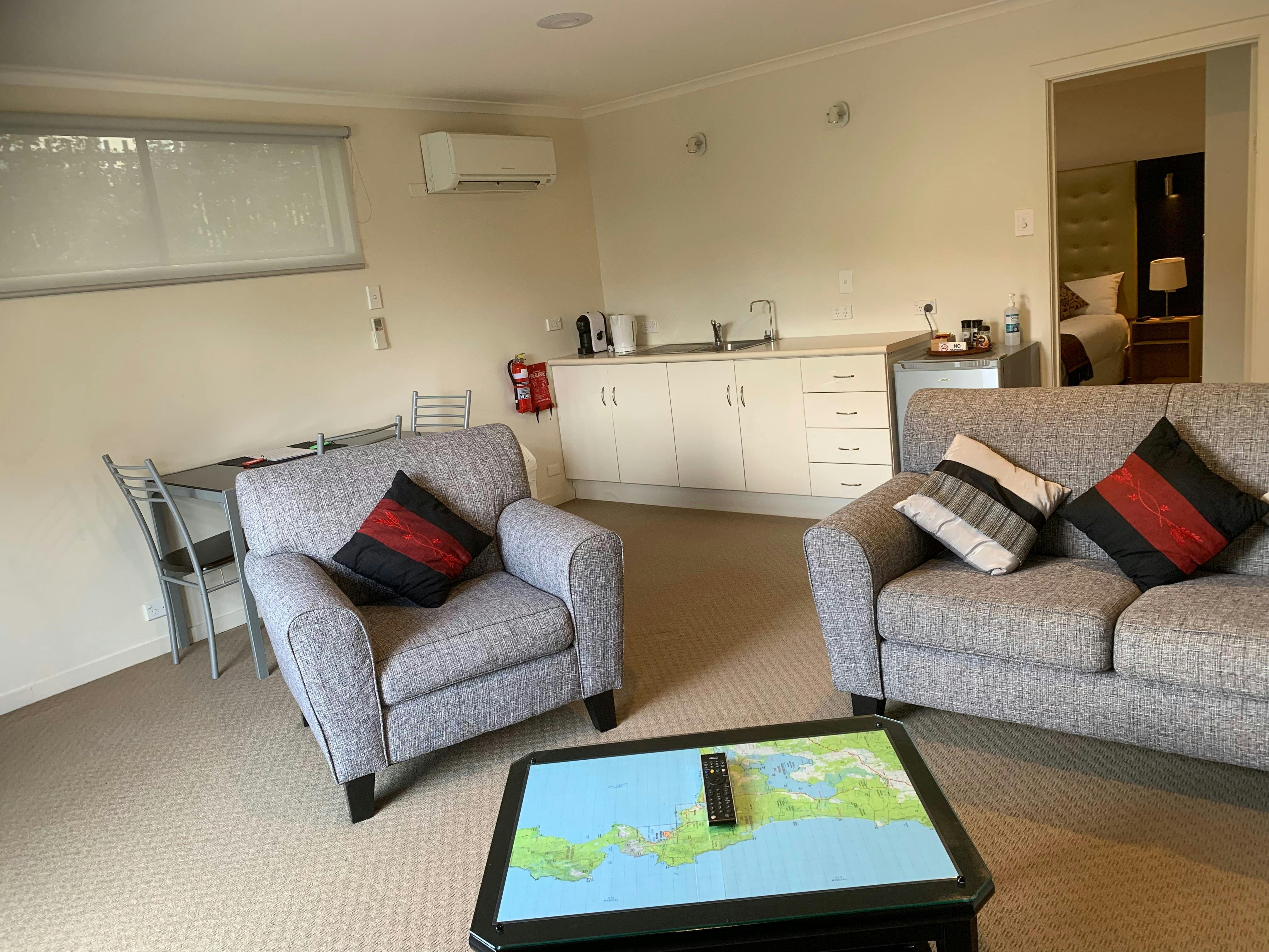 Living area with kitchenette in the background