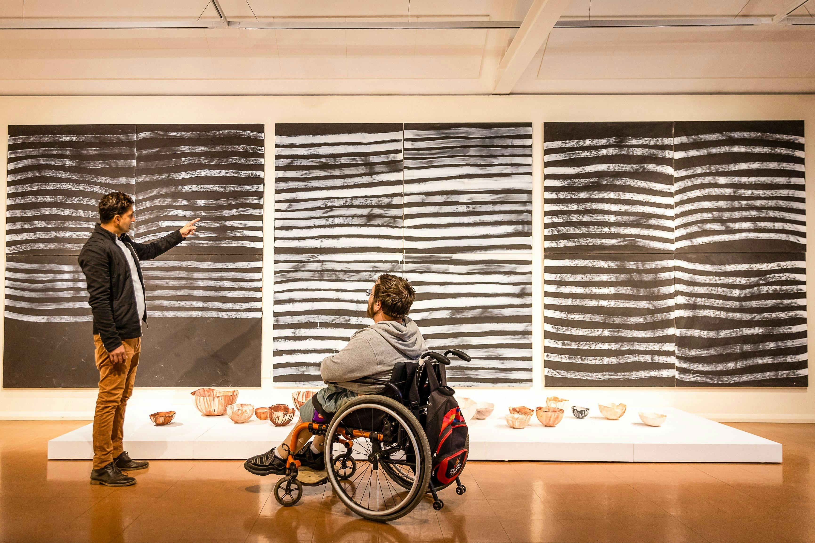 Two people viewing art at Araluen Arts Centre