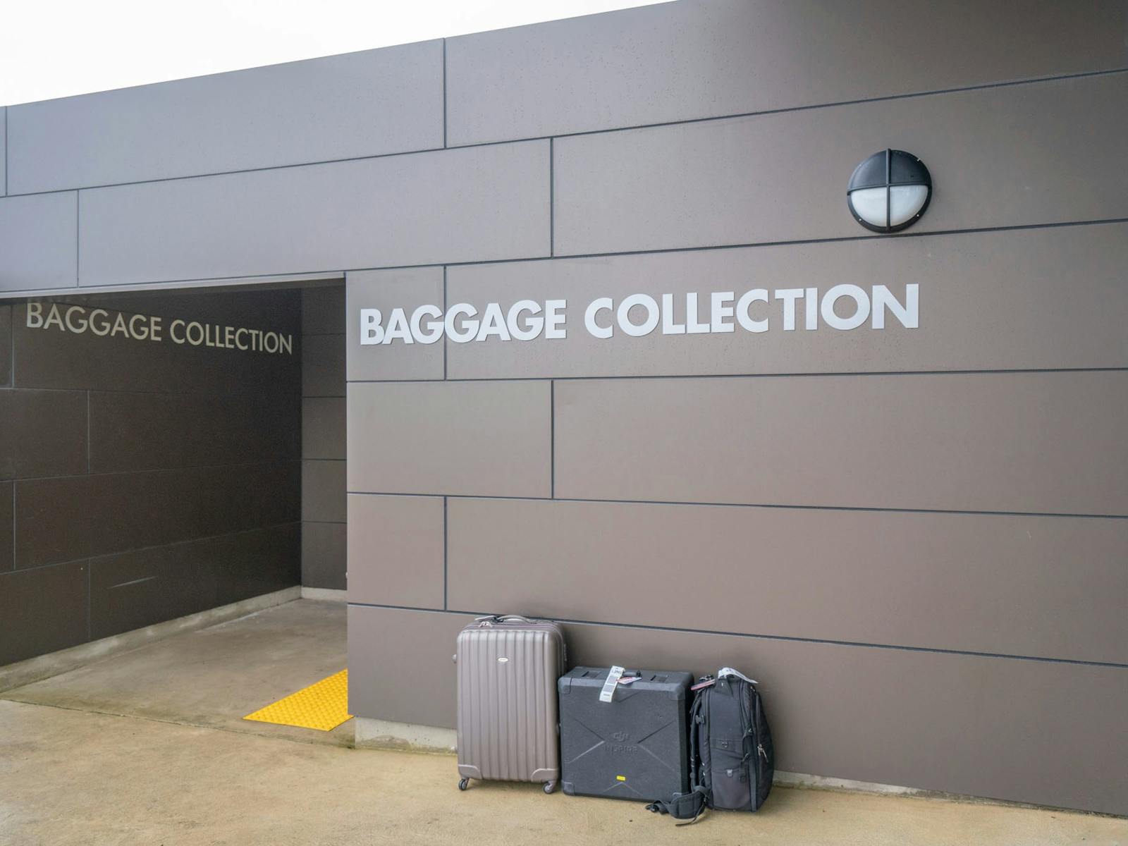 Suitcases sitting outside baggage collection area