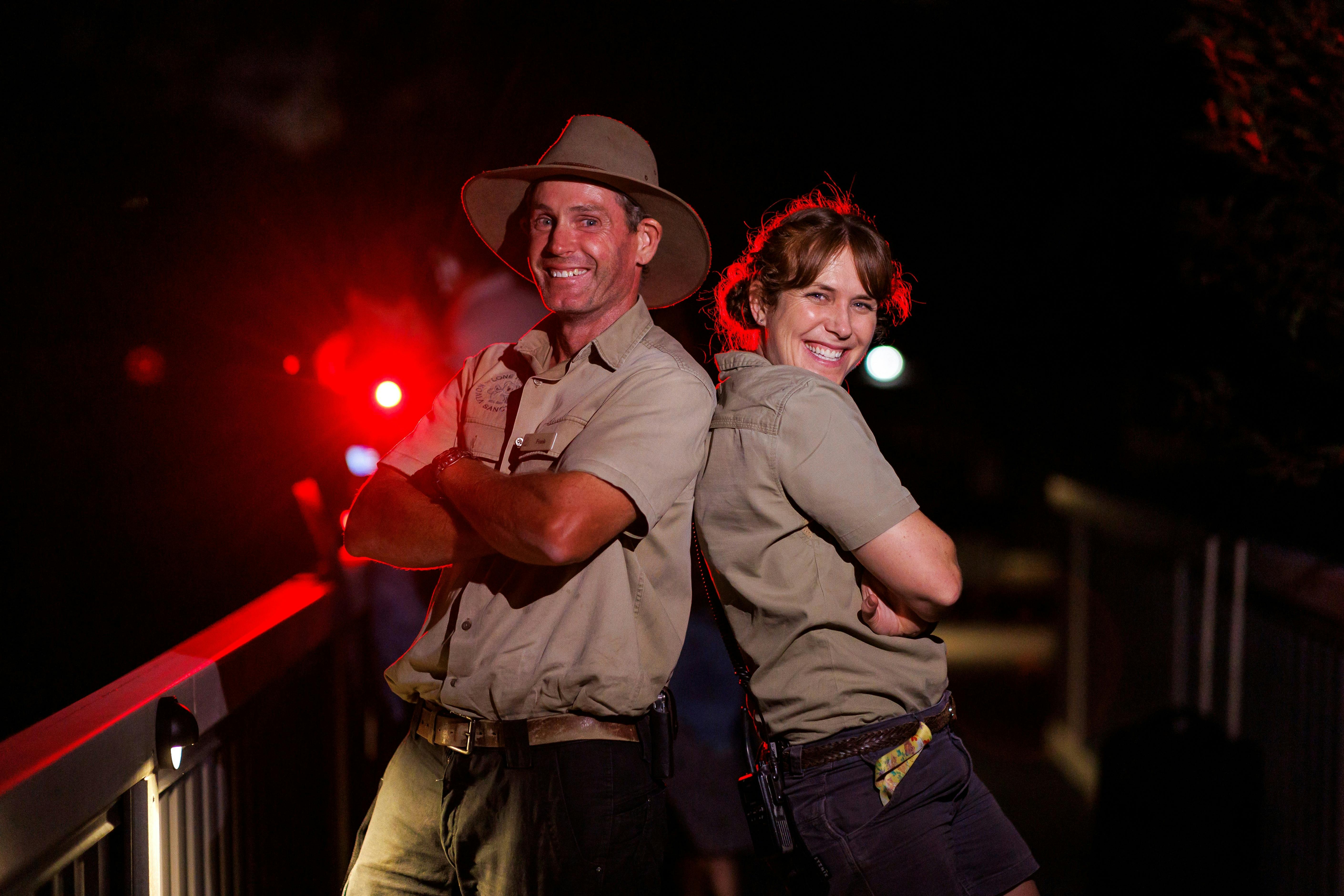 Two wildlife keepers posing back to back at Lone Pine Nocturnal night tours