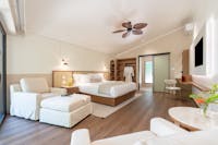 Nala Resort's luxurious Studio Suite - king bed, lounge chairs and ottomans, desk and mini bar