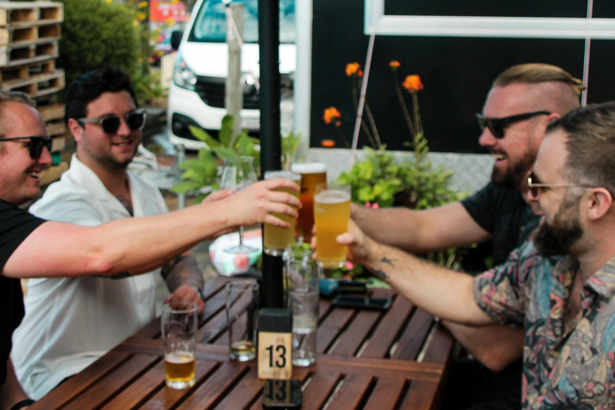 Group of friends cheers beer