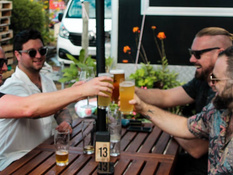 Group of friends cheers beer