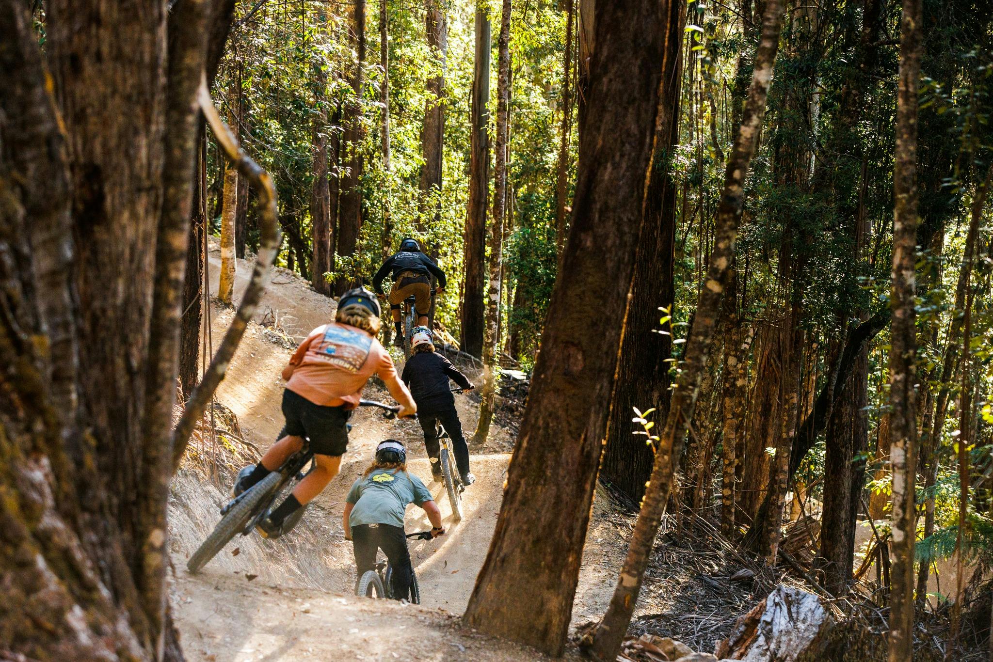 Riders on bicycles riding down single track at Maydena Bike Park