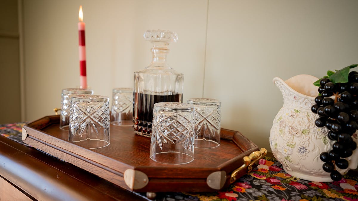 Port, port glasses and candle presented on historic furniture piece