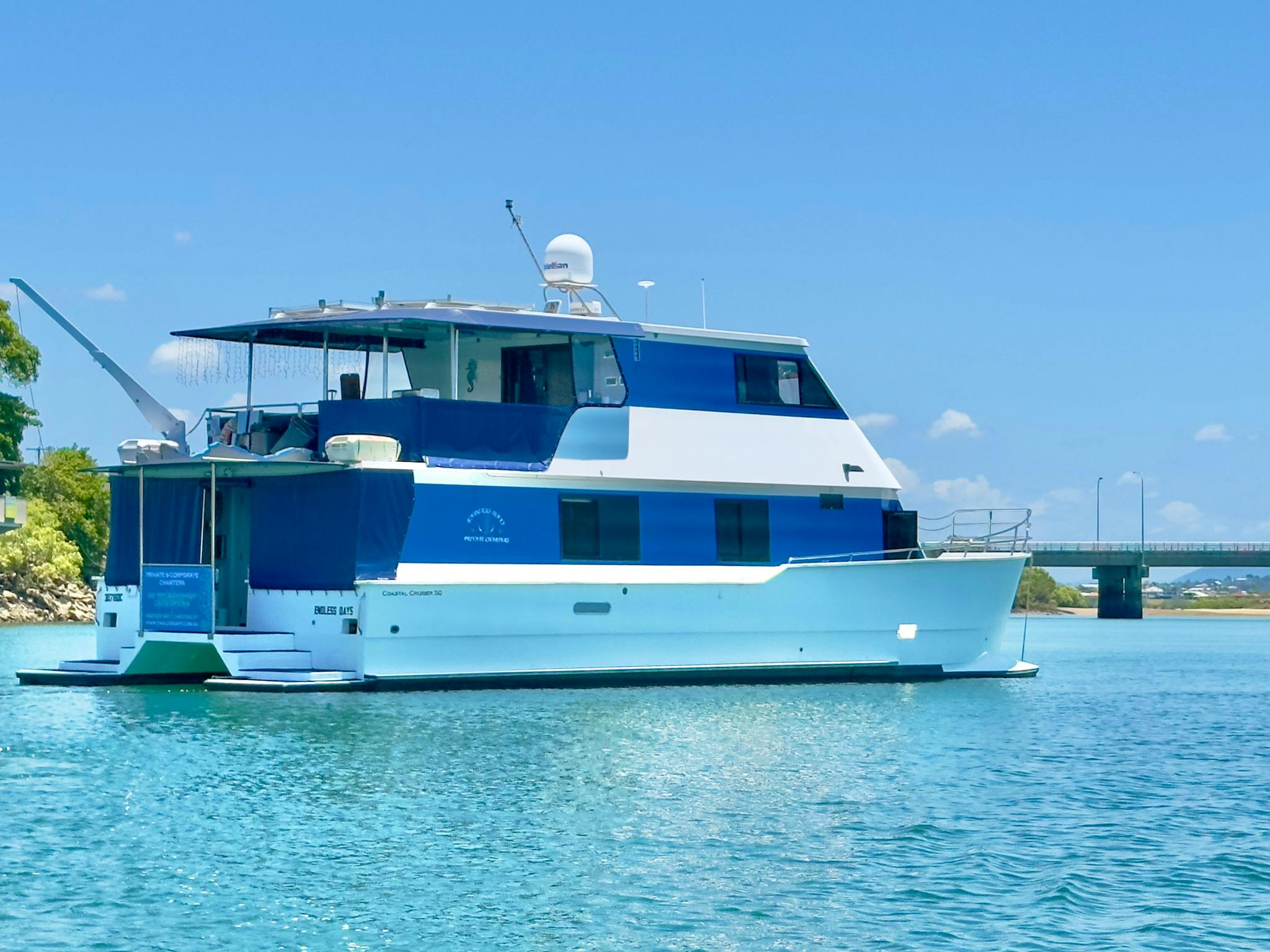 Image of large catamaran boat anchored in river Image of large catamaran boat anchored in river
