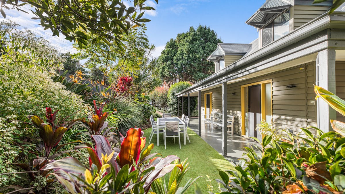 A private courtyard view of Gingers House with outdoor table and chairs and gardens