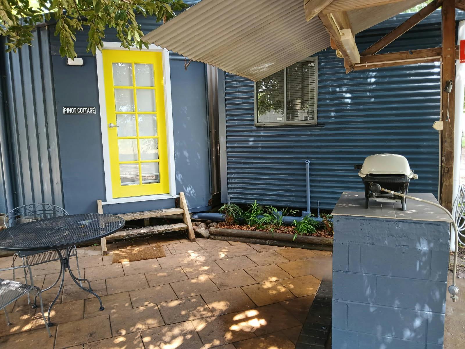 Pinot Cottage exterior with some seating