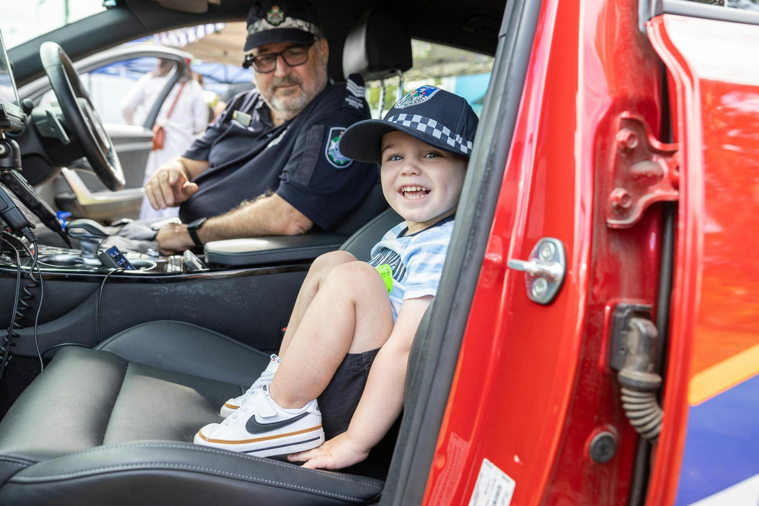 Kid in _police car at Emergency Services Expo