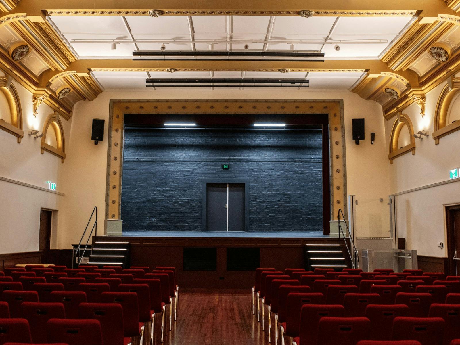 The interior of the Deniliquin Town Hall, with stage and seating