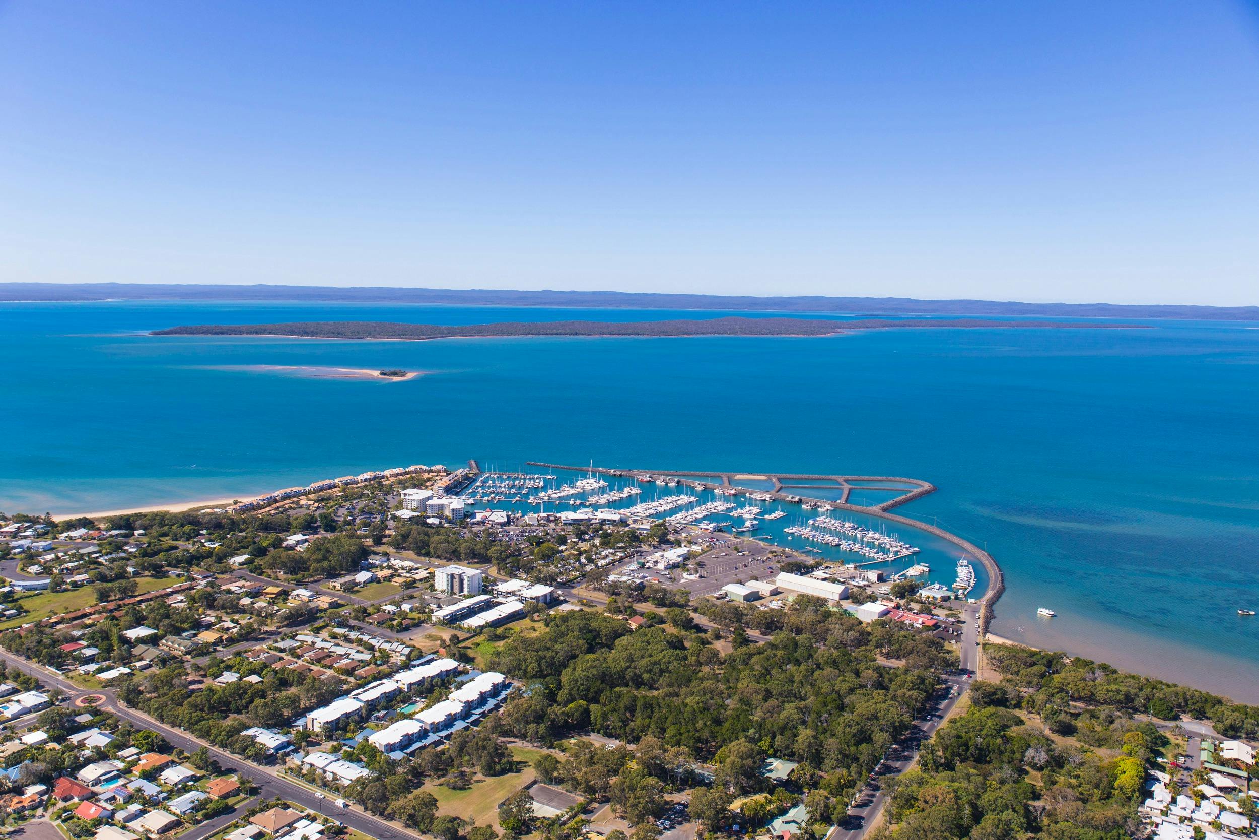 Aerial photo of the marina at Hervey Bay with views over to Fraser Island in the background.