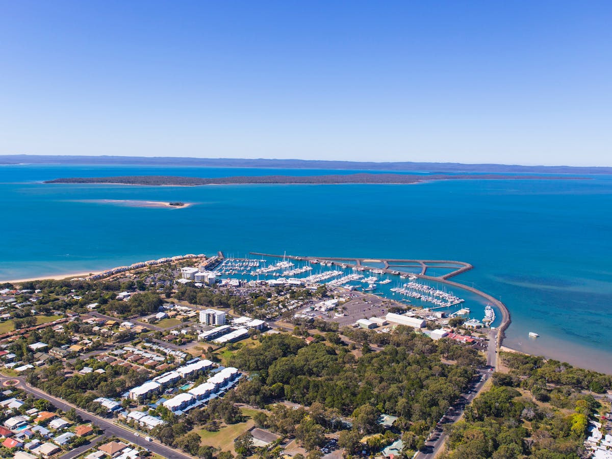 Aerial photo of the marina at Hervey Bay with views over to Fraser Island in the background.