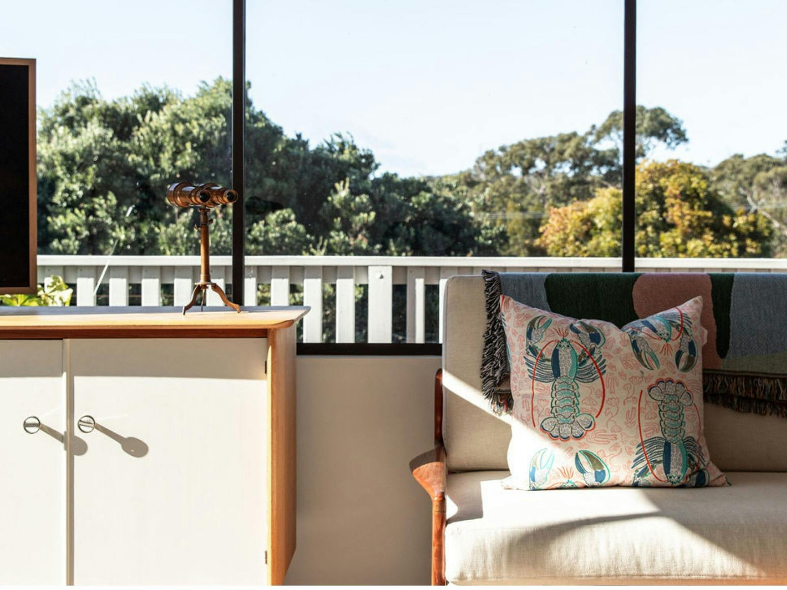 Sun soaked lounge room, binoculars and bush
