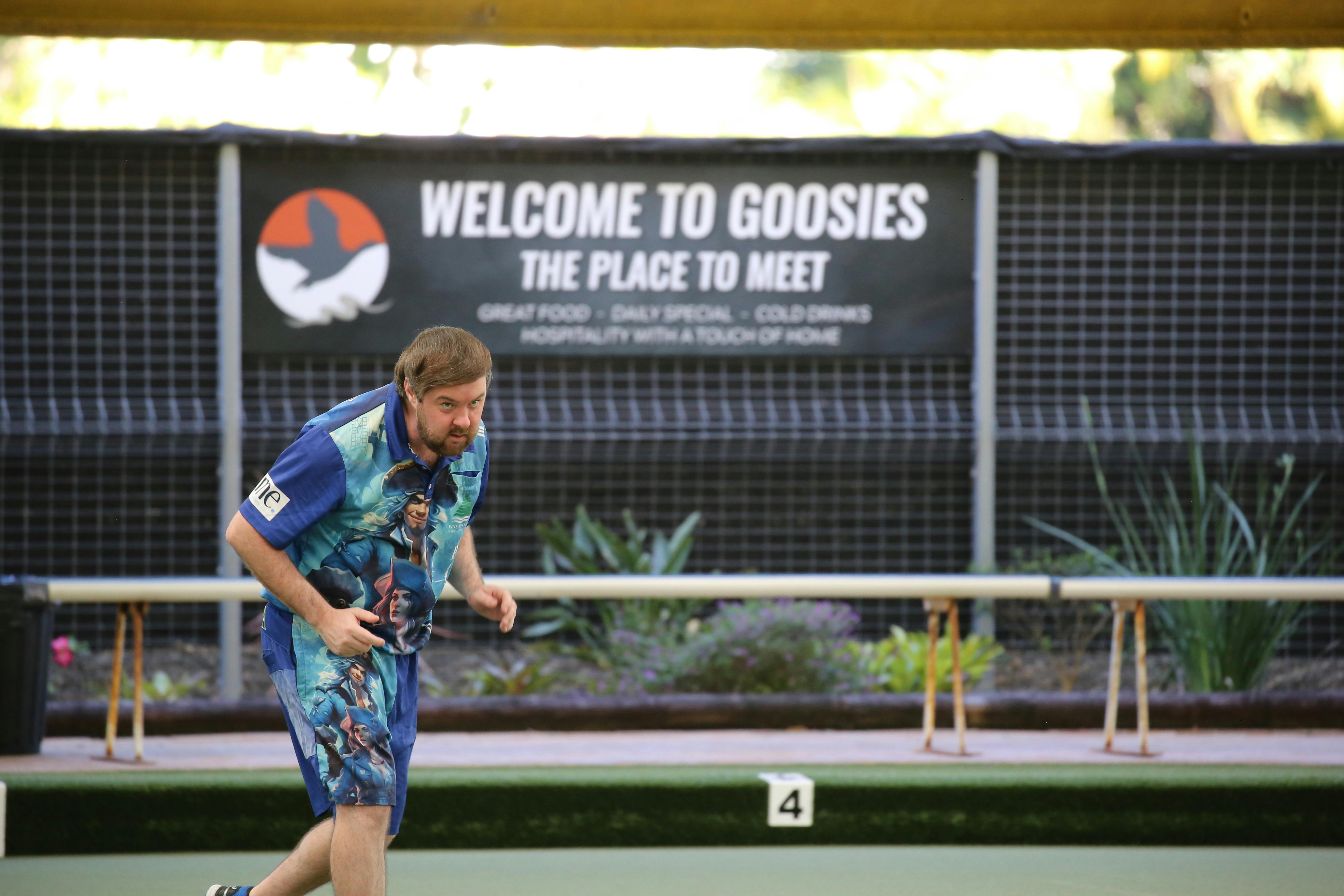 Lawn bowls player bowling