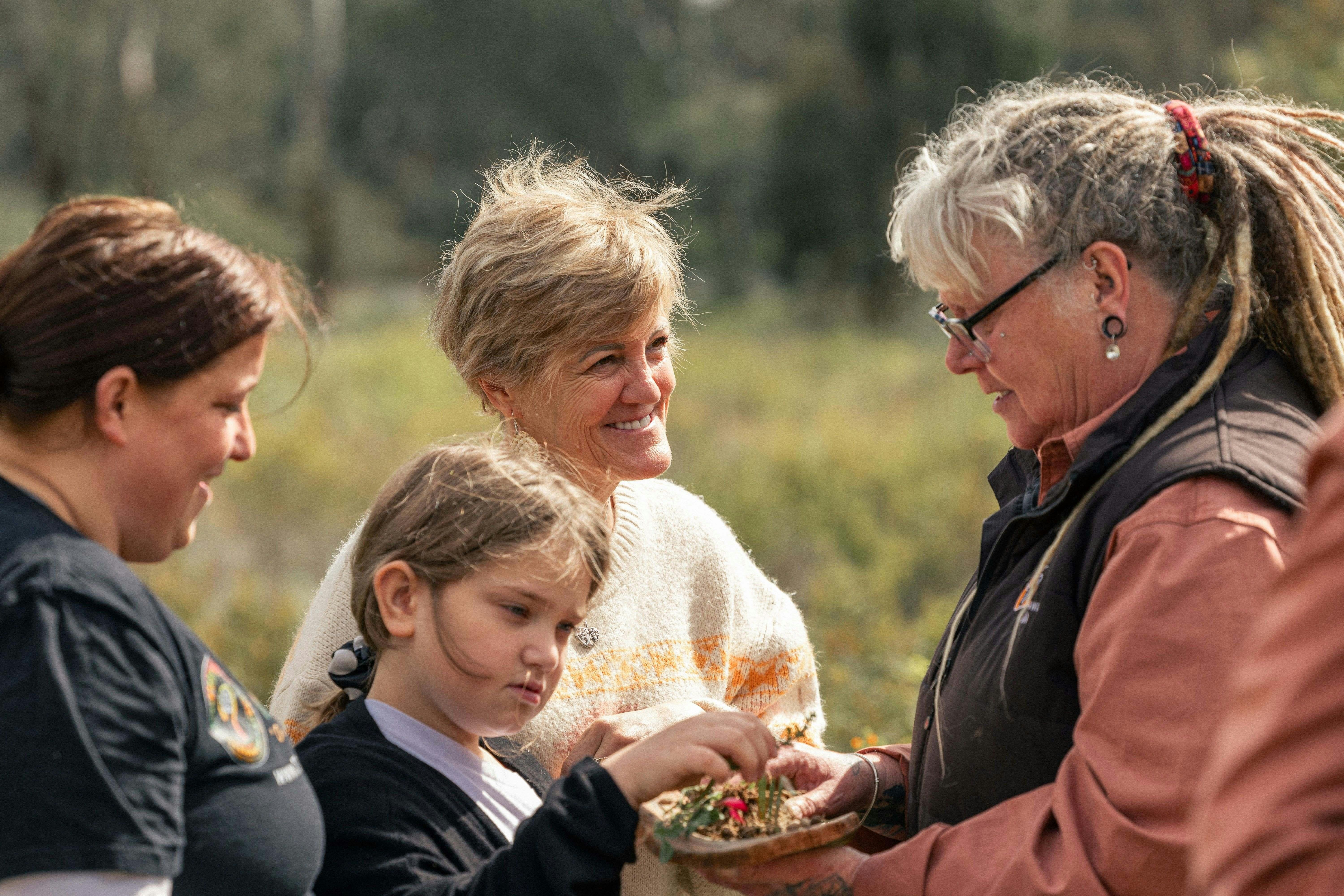 family eating bush tucker from guide