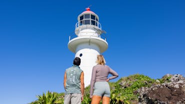 Two people looking up at the Lighthouse Two people looking up at the Lighthouse