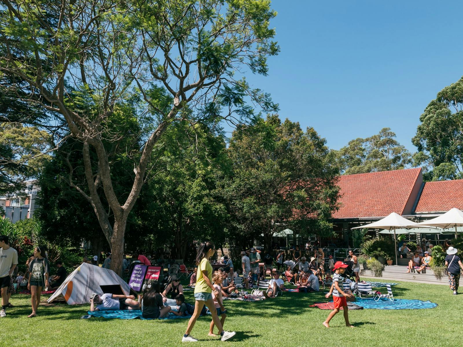 People sitting in gardens at open day event