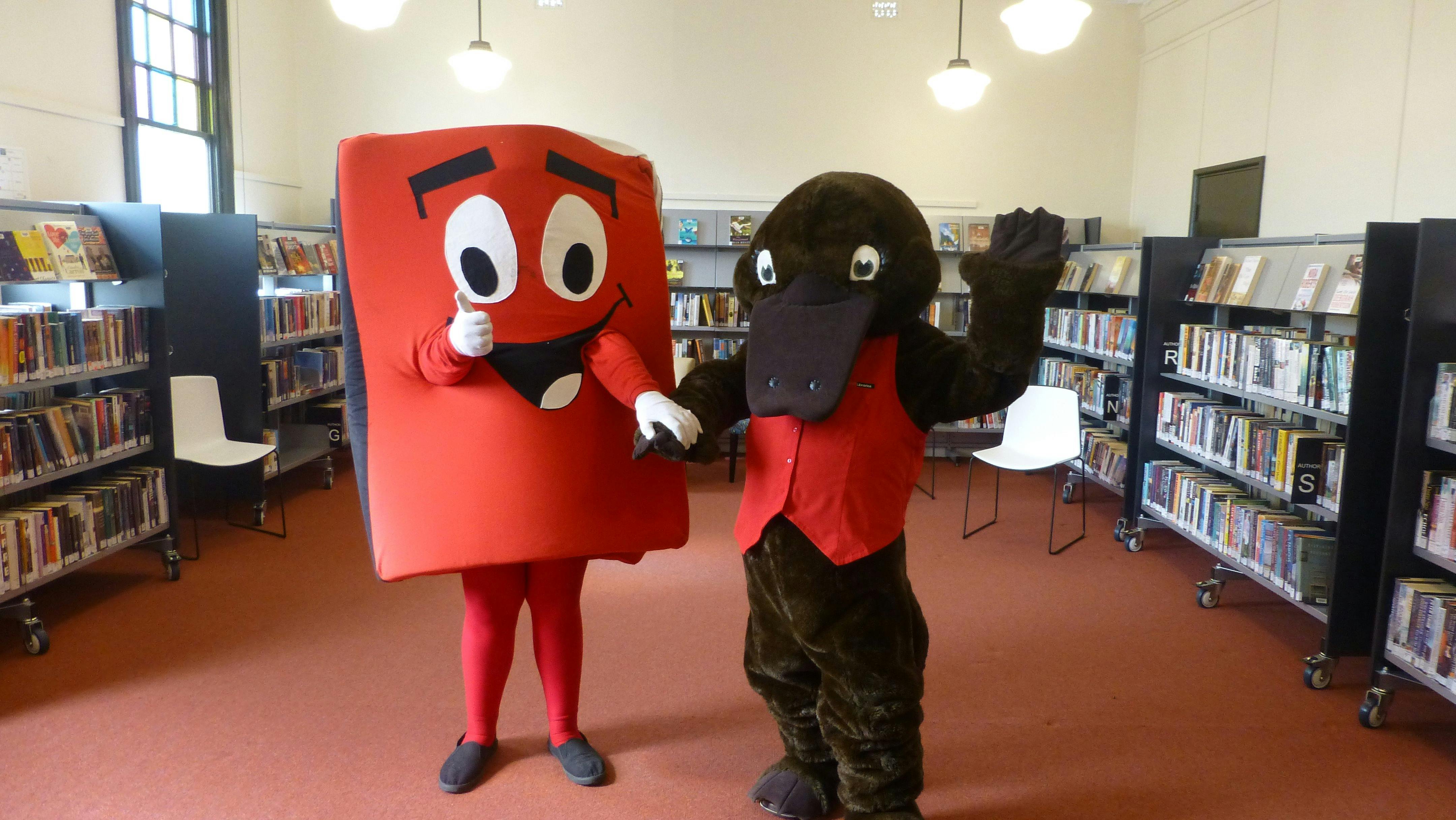 Reading mascots Book Bob, shpaed like a book and gint platypus Freed the Reader at Forbes Library