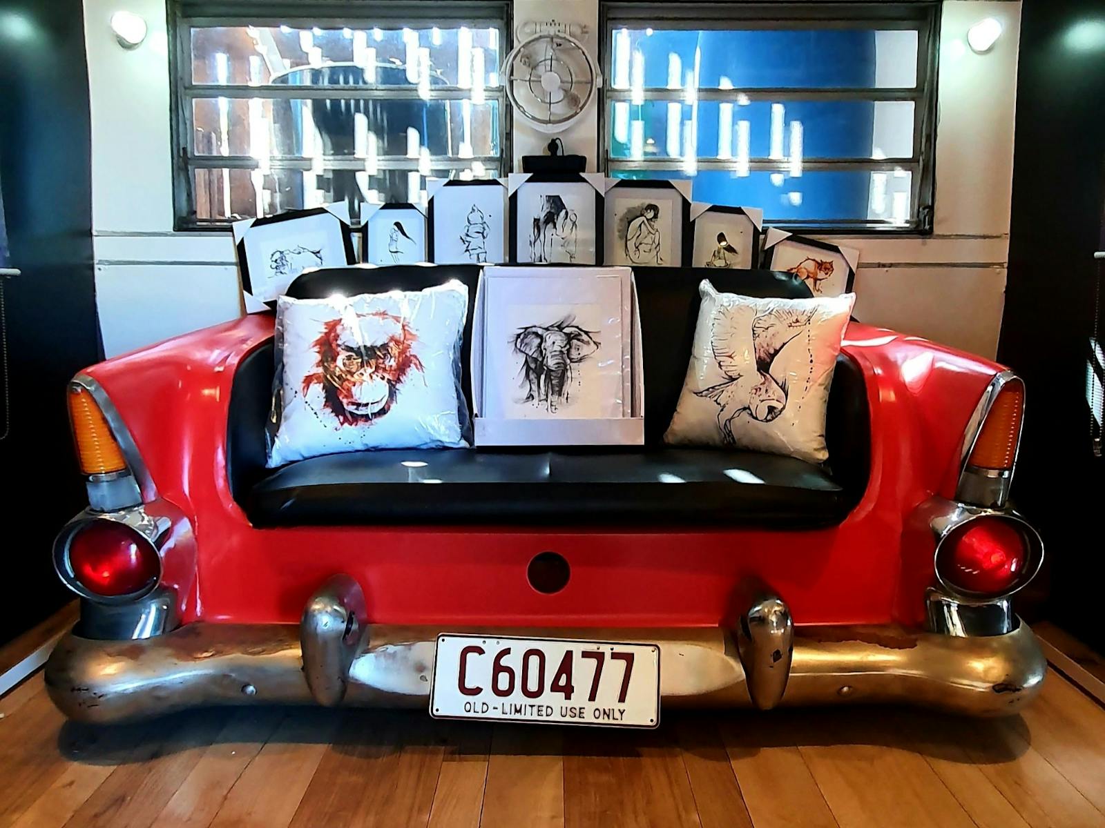 photo of red car seat with artworks sitting on it photo of red car seat with artworks sitting on it