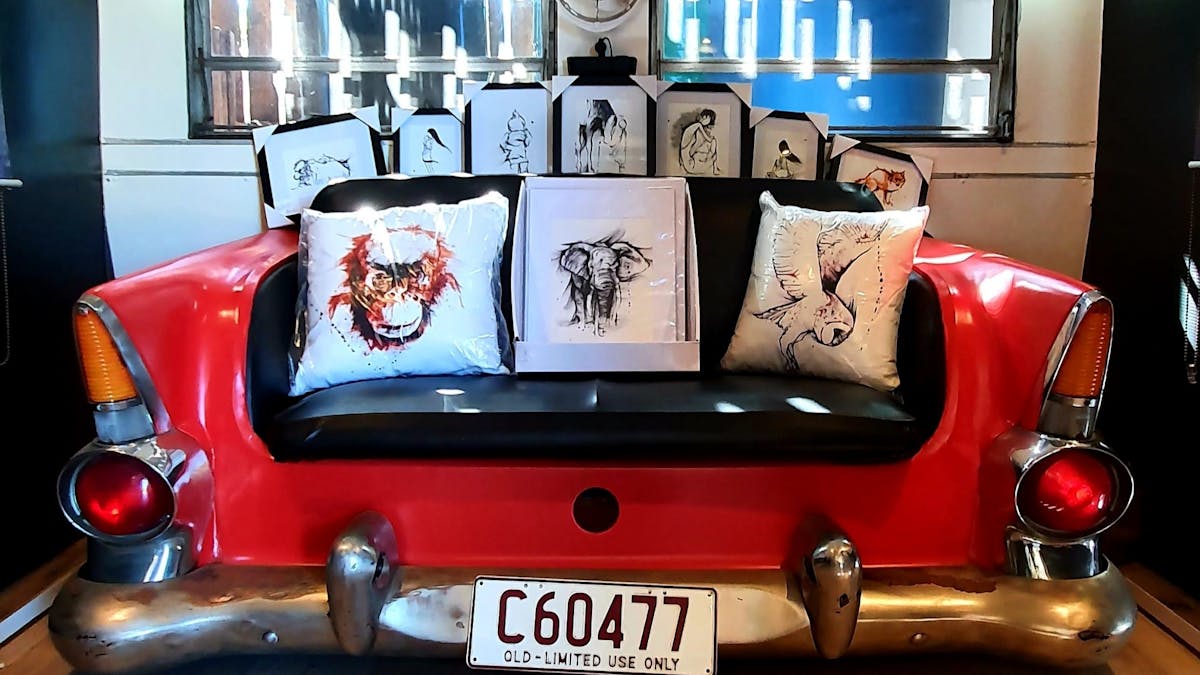 photo of red car seat with artworks sitting on it