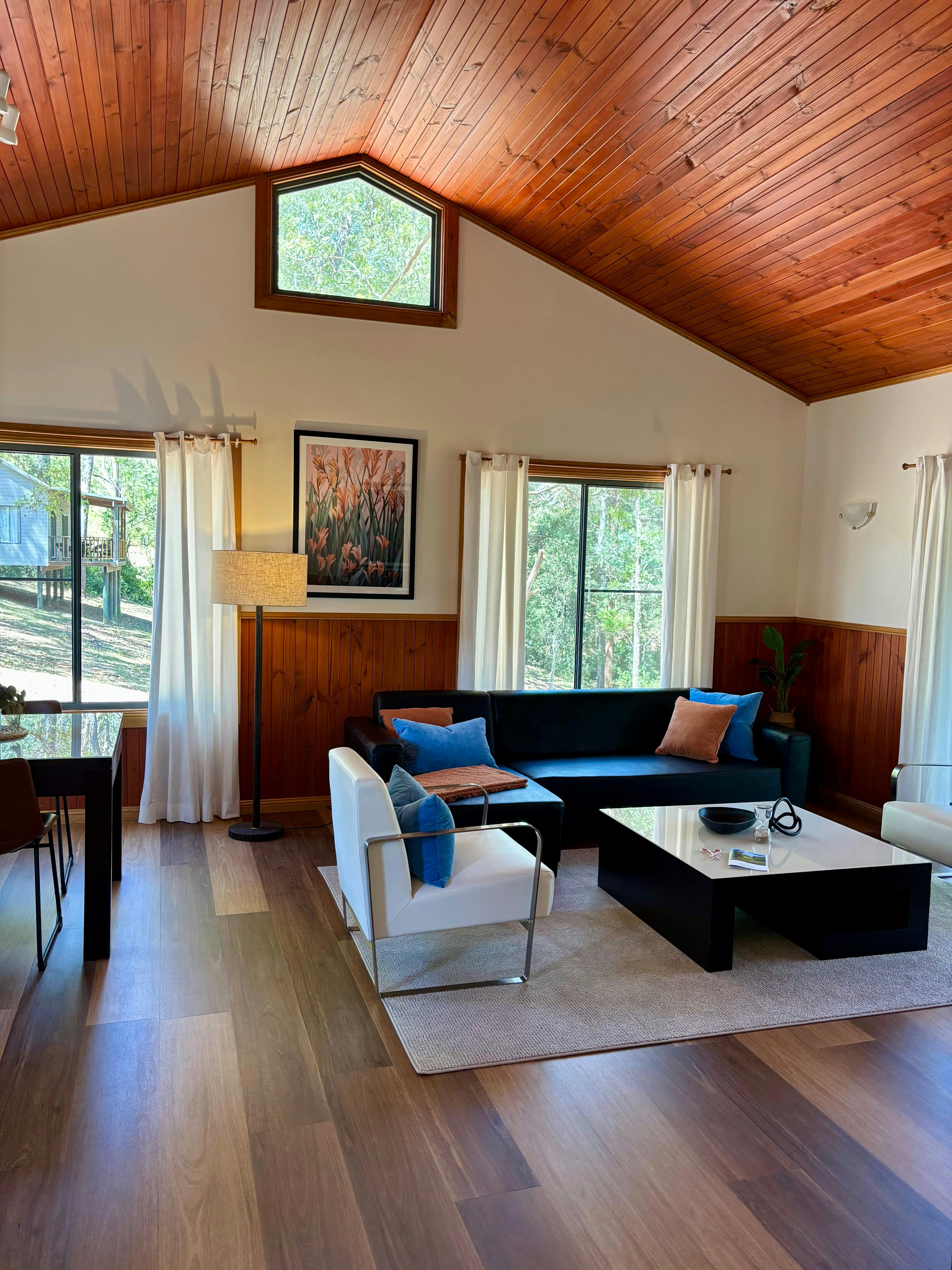 Image of the cottage with elegant furniture and grand ceiling withg wood trim