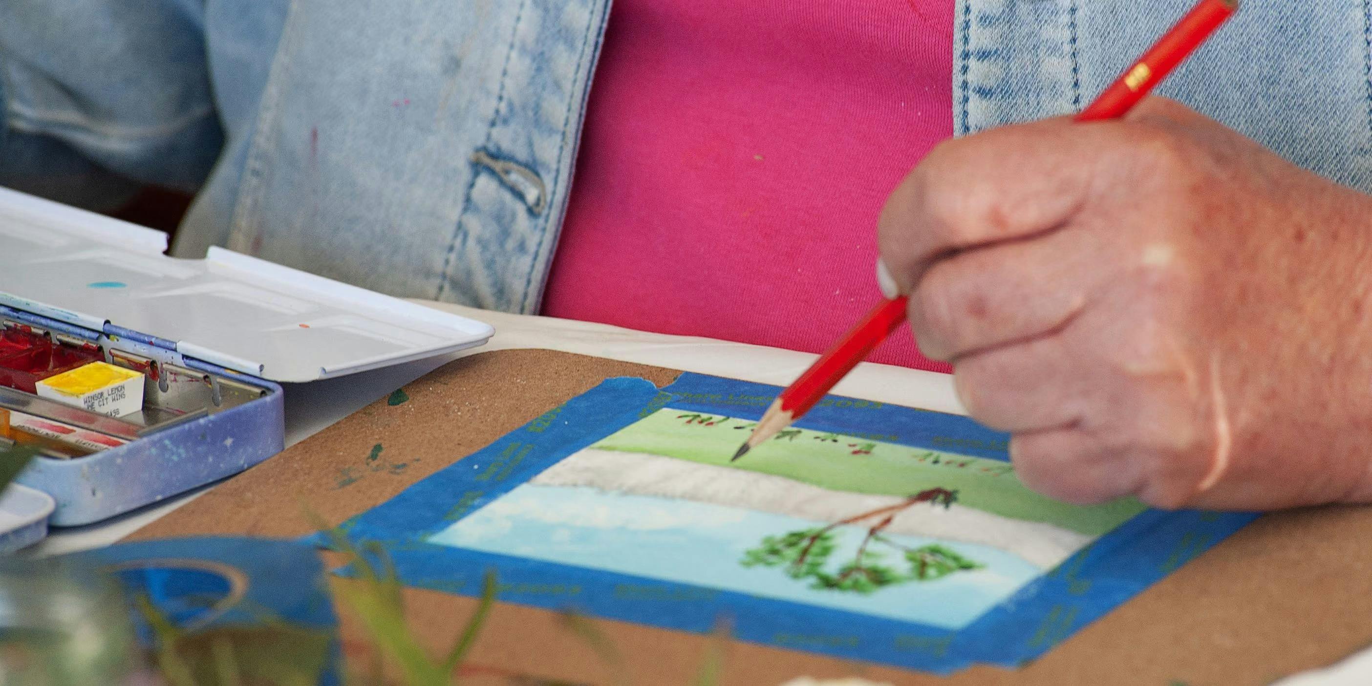 Somone drawing on watercolour painting